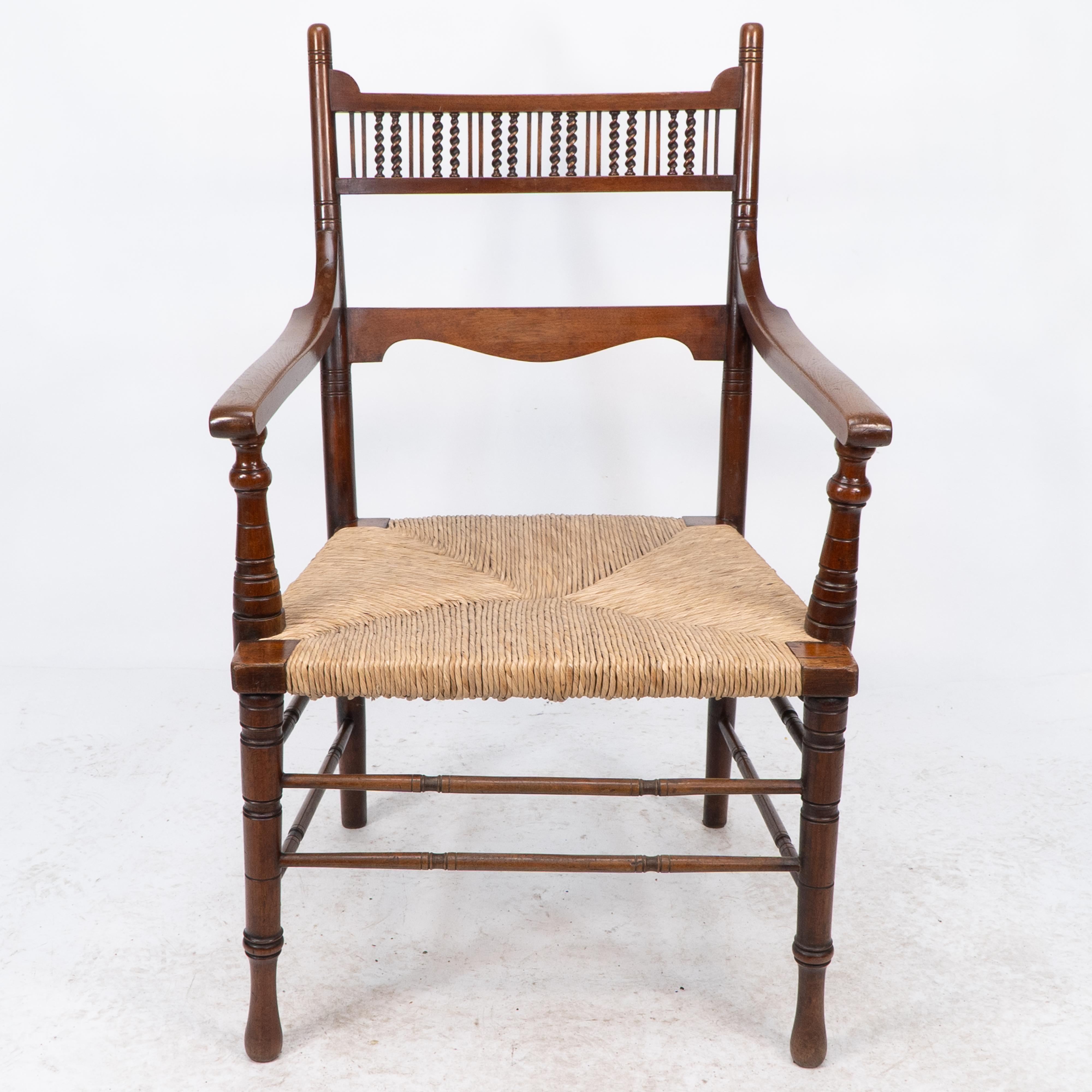 George Bell & George Freeth Roper. Probably made by Kendal Milne & Co for Herman Schill. An Aesthetic Movement Walnut armchair with a row of fine barley twist turnings to the upper back, and a shaped back rest below. The back legs curving back with
