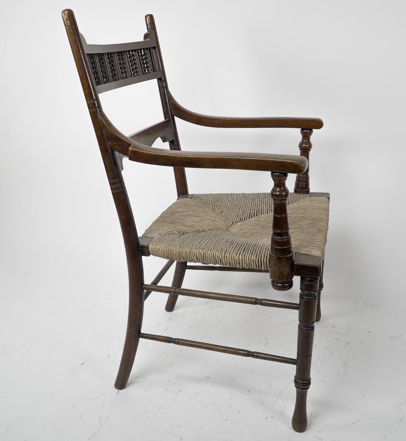 Late 19th Century George Bell & George Freeth Roper Aesthetic Movement Walnut rush seat armchair. For Sale