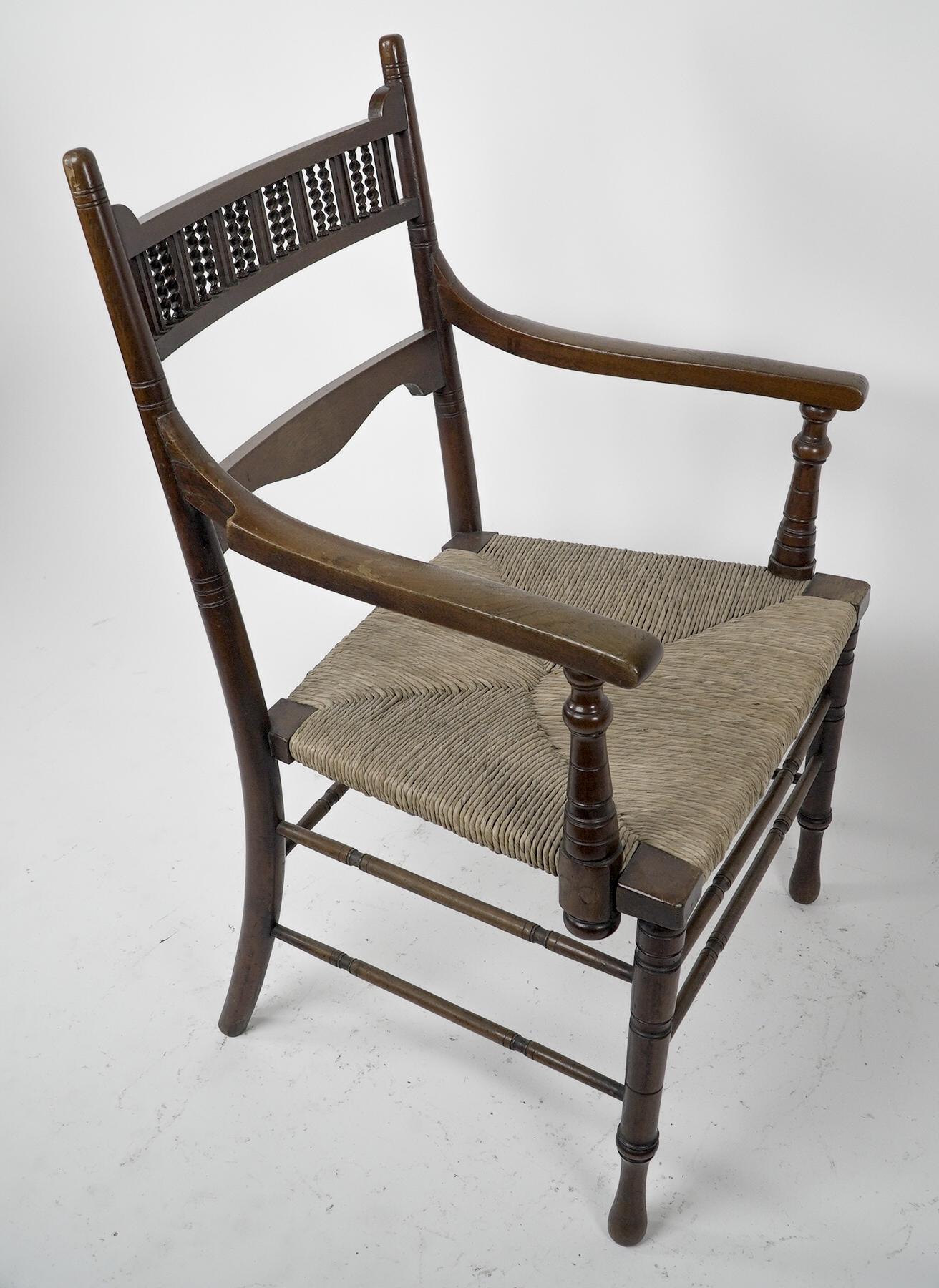 English George Bell & George Freeth Roper Aesthetic Movement Walnut rush seat armchair. For Sale