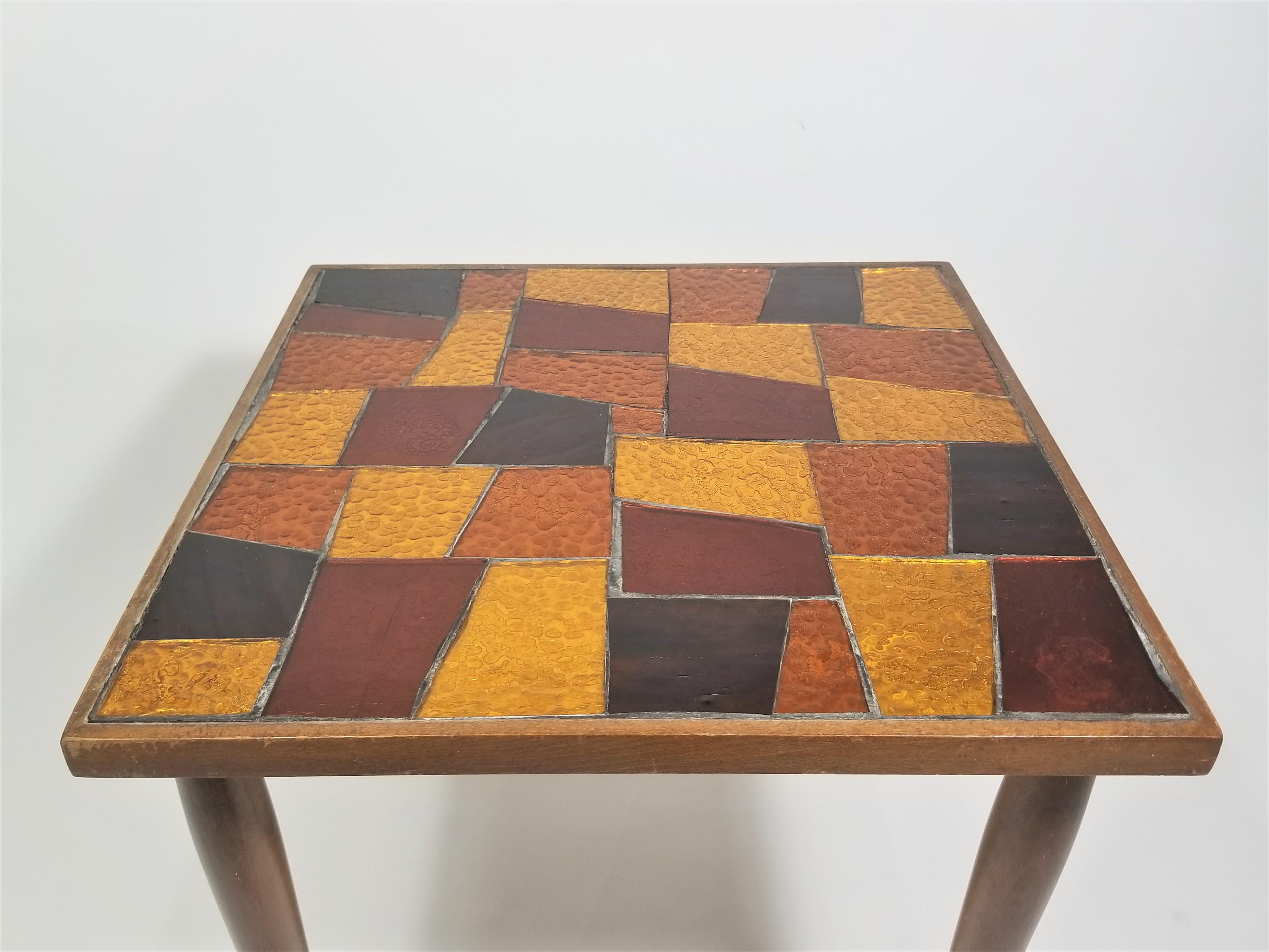 1960s Mid Century George Briard mosaic side table or small cocktail table or accent table. Cut glass mosaic of Autumn colors brown, orange and gold. Walnut base. 
Made in Yugoslavia.