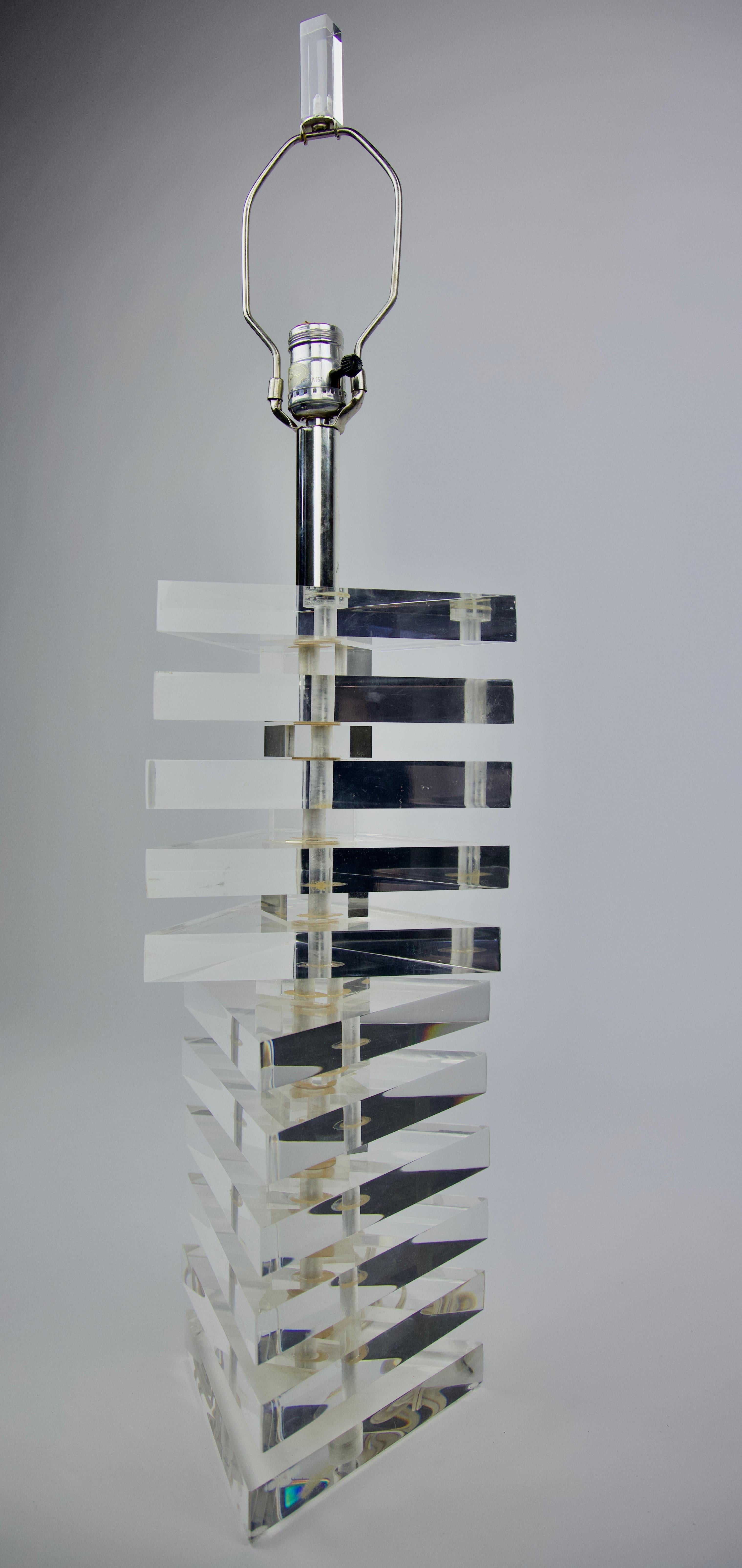 George Bullio, Stacked Triangle Lucite lamp 
with Lucite finial in the manner of Karl Springer. Three-way switch. Shade not included.
Architectural 1