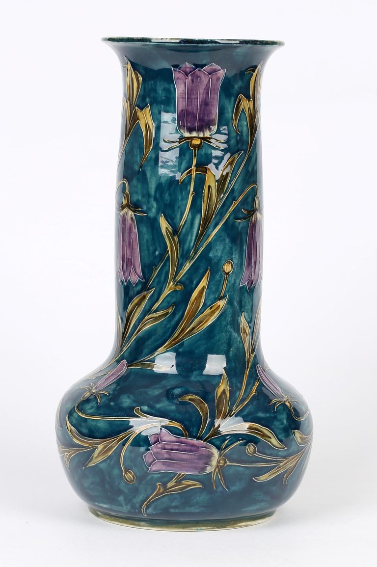 A stunning and large early Art Deco Hancock & Sons Morrisware hand painted art pottery vase with flowering harebells by George Cartlidge dating circa 1918. This tall and striking vase stands on a narrow rounded foot with a wide rounded ball shaped