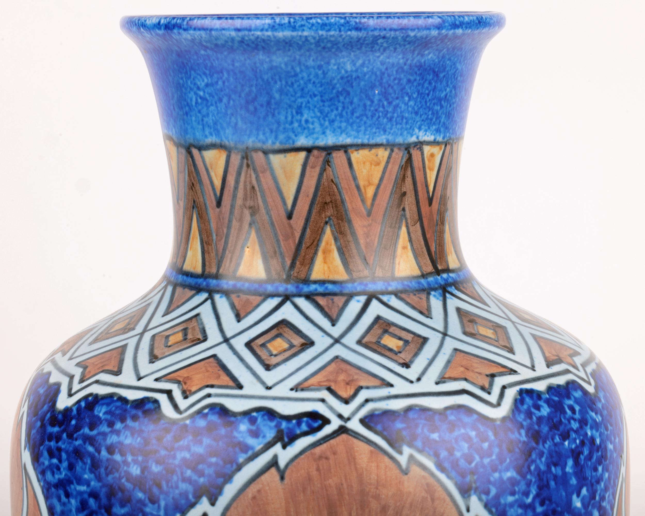 A very large and impressive Art Deco George Clews & Co, Tunstall, Chameleon Ware hand painted vase with leaves dating from around 1925. The finely potted earthenware vase stands raised on a narrow-skirted rim with recessed base and is of large