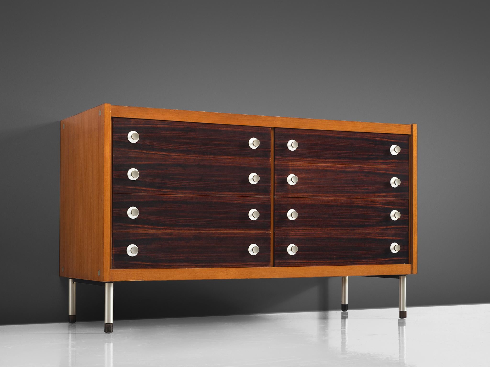 George Coslin, chest of drawers, teak and rosewood, metal, Italy, 1950s.

This cabinet is executed in teak and has eight drawers. The legs and handles are made of metal and are circular. The cabinet is simplistic and its main feature is the color