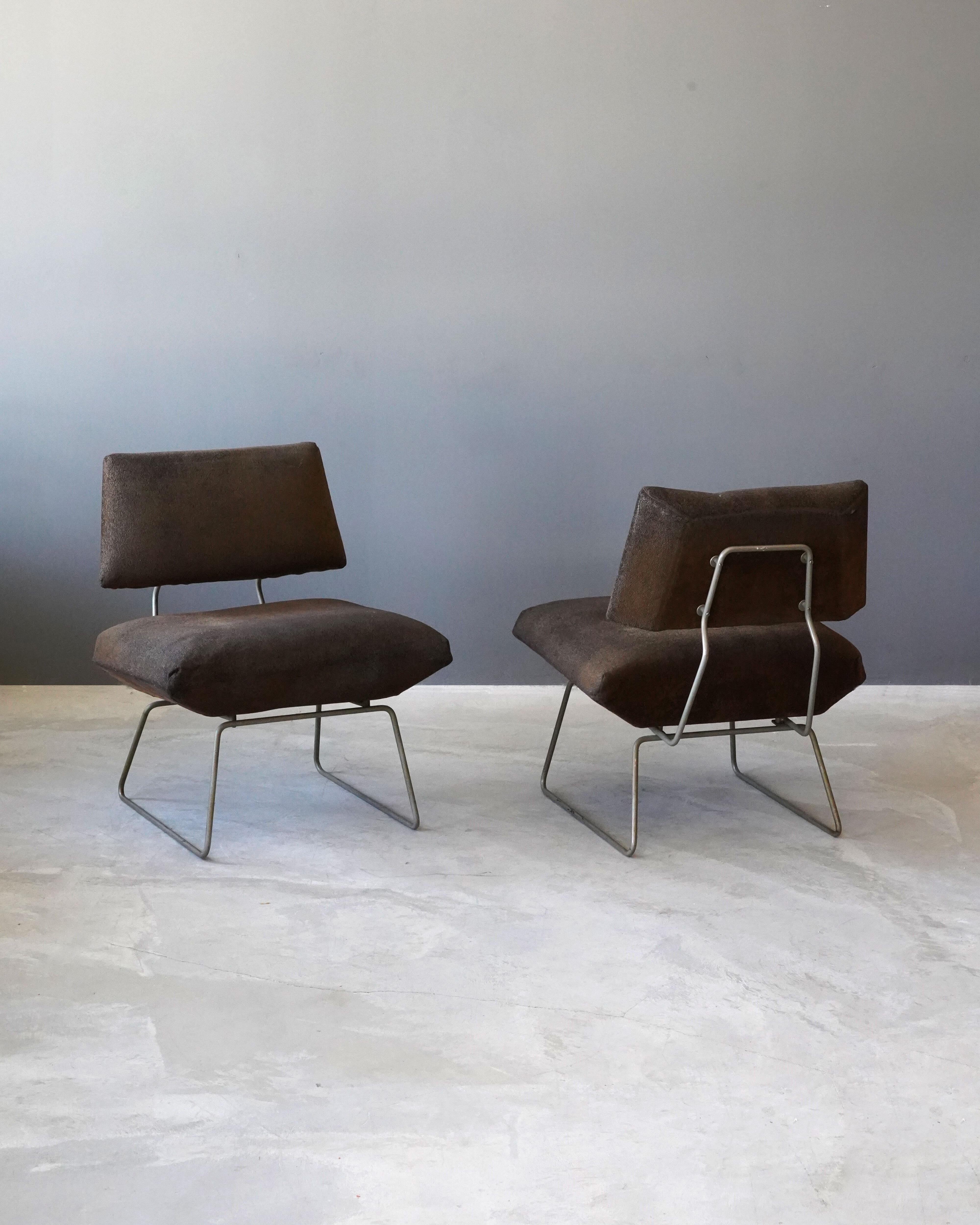 A pair of minimalist lounge chairs / slipper chairs. Designed by George Coslin Italy, 1960s. Metal frame supports overstuffed seat and back upholstered in it's original vintage fabric.

Litterature: Catalogo del produttore, Trevi Spa, foto di