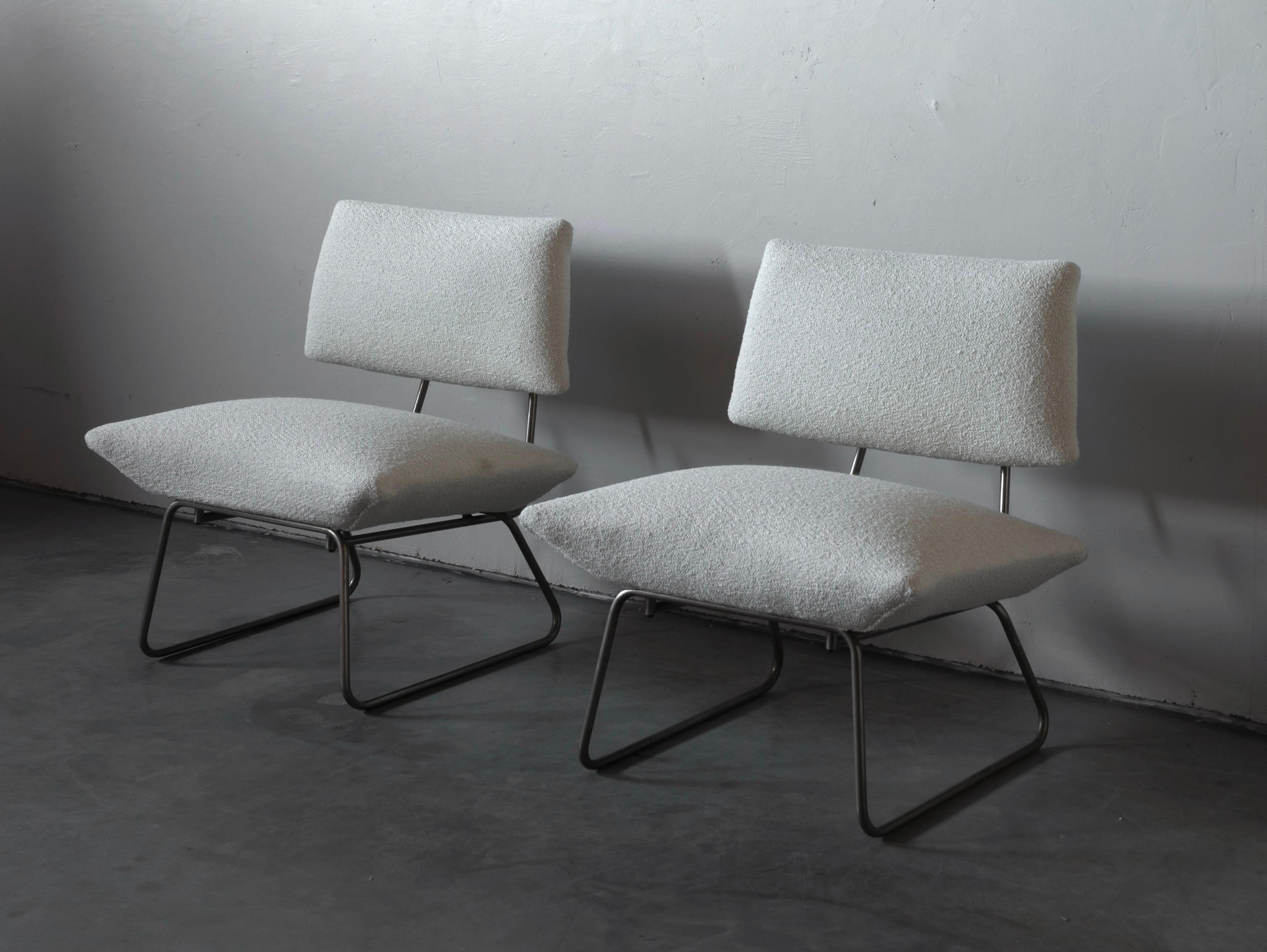 A pair of minimalist lounge chairs / slipper chairs. Designed by George Coslin Italy, 1960s. Metal frame supports overstuffed seat and back upholstered in it's original vintage fabric. Reupholstered in brand new high end bouclé