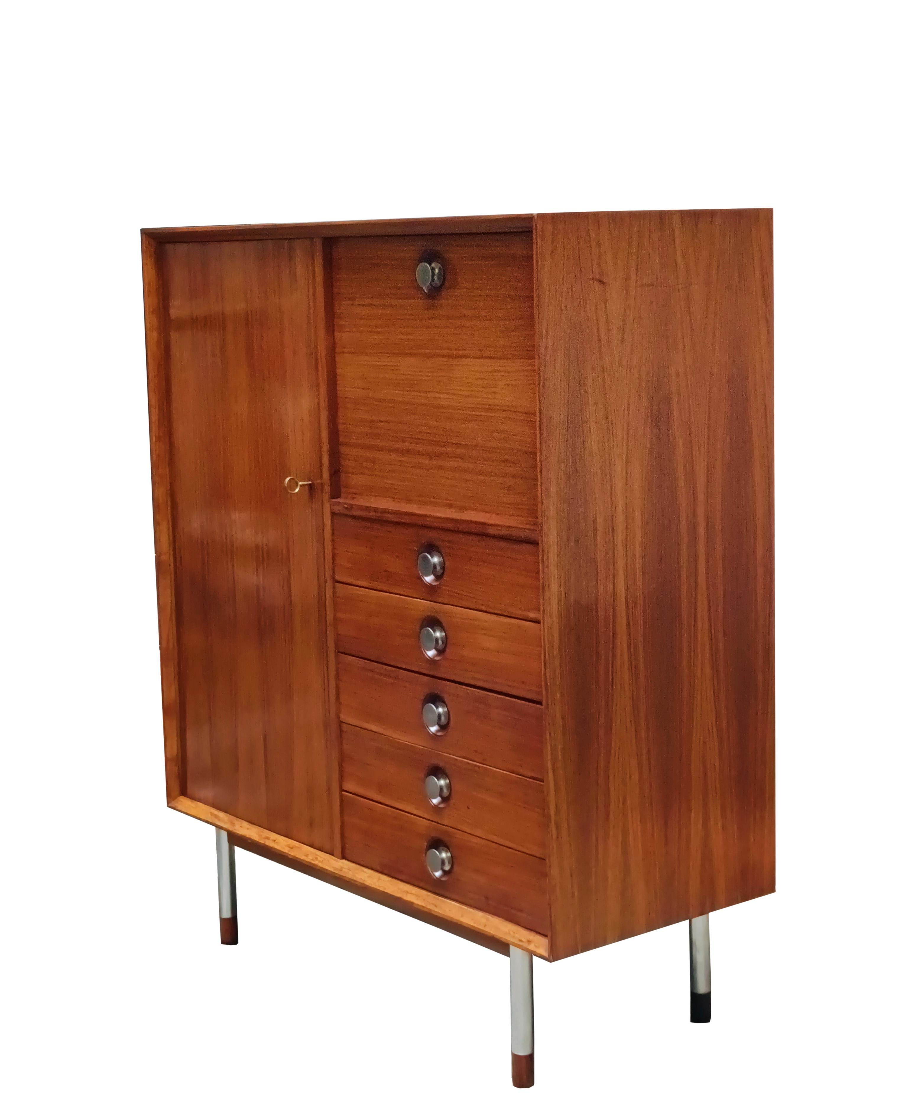 Rare armoire en bois  couleur miel conçu par George Coslin pour FARAM, Italie 1960
Le meuble comporte 5 tiroirs avec boutons en métal chromé, un abattant avec étagères et un placard, les pieds en bois foncé et métal. 
En très bon état, avec peu de