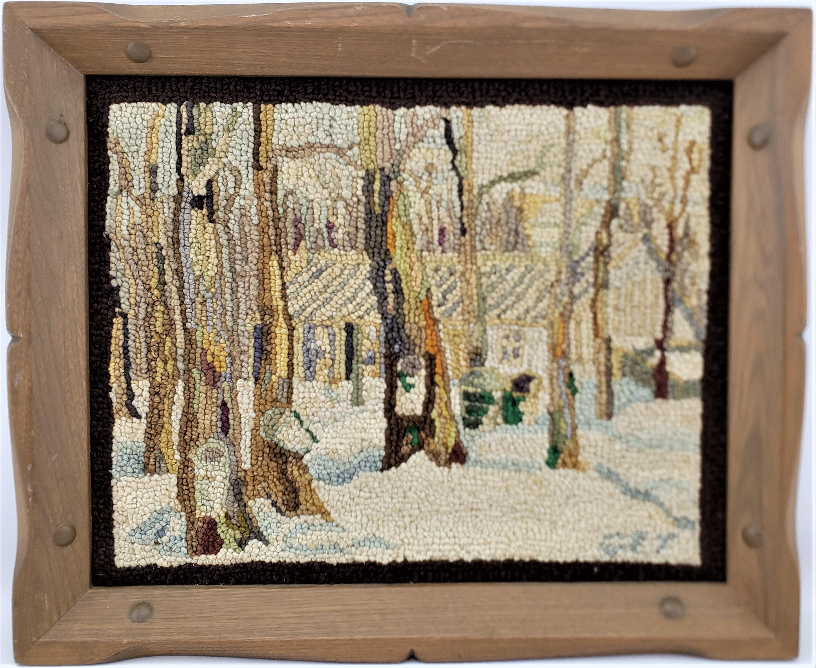 This framed hooked rug or mat was done by the well known George Edouard Tremblay of Quebec Canada in approximately 1940 in his period Folk Art style. The rug or mat is done with wool, presumably on burlap and framed in a rustic styled wooden frame.