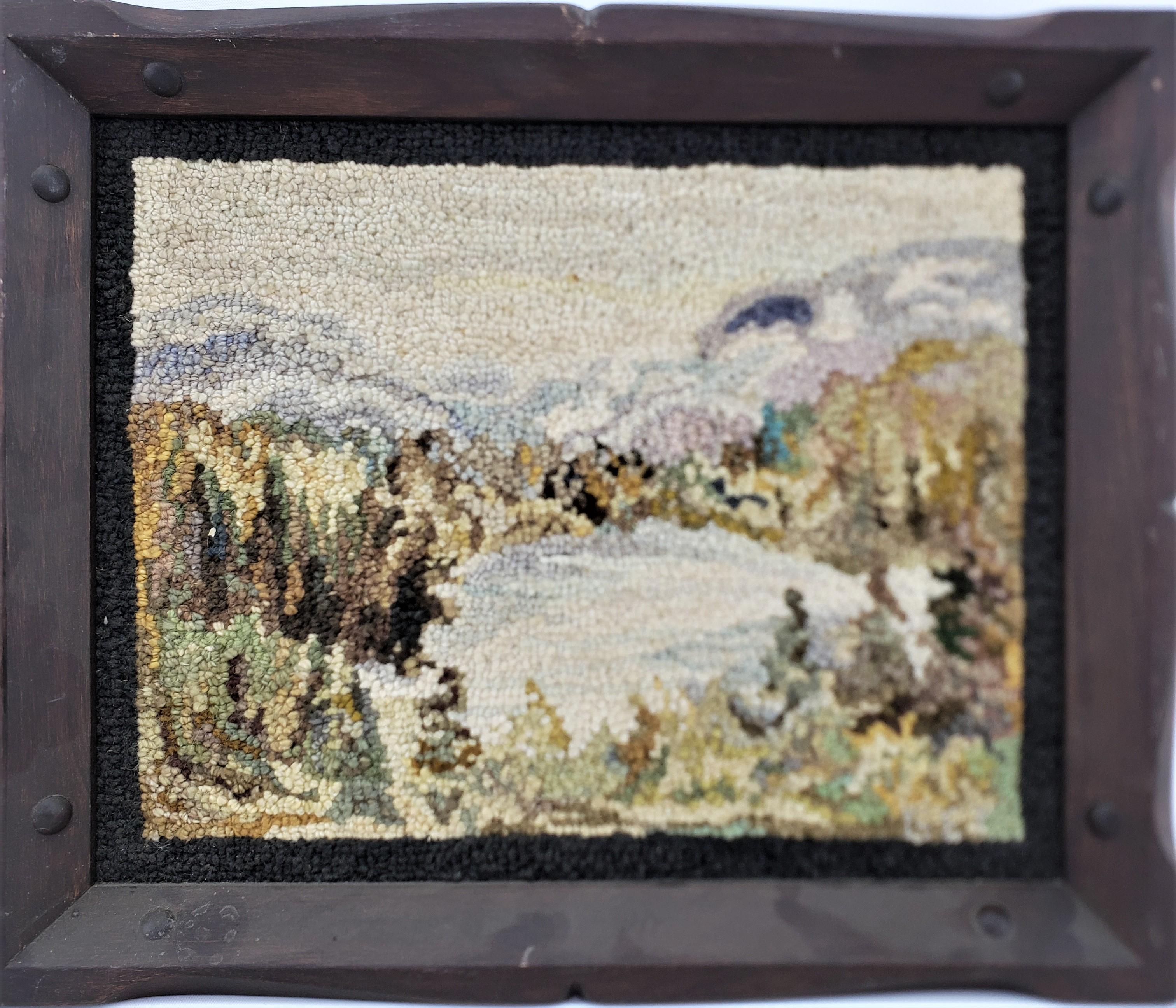 This framed hooked rug or mat was done by the well known George Edouard Tremblay of Quebec Canada in approximately 1940 in his period Folk Art style. The rug or mat is done with wool, presumably on burlap and framed in a rustic styled wooden frame.