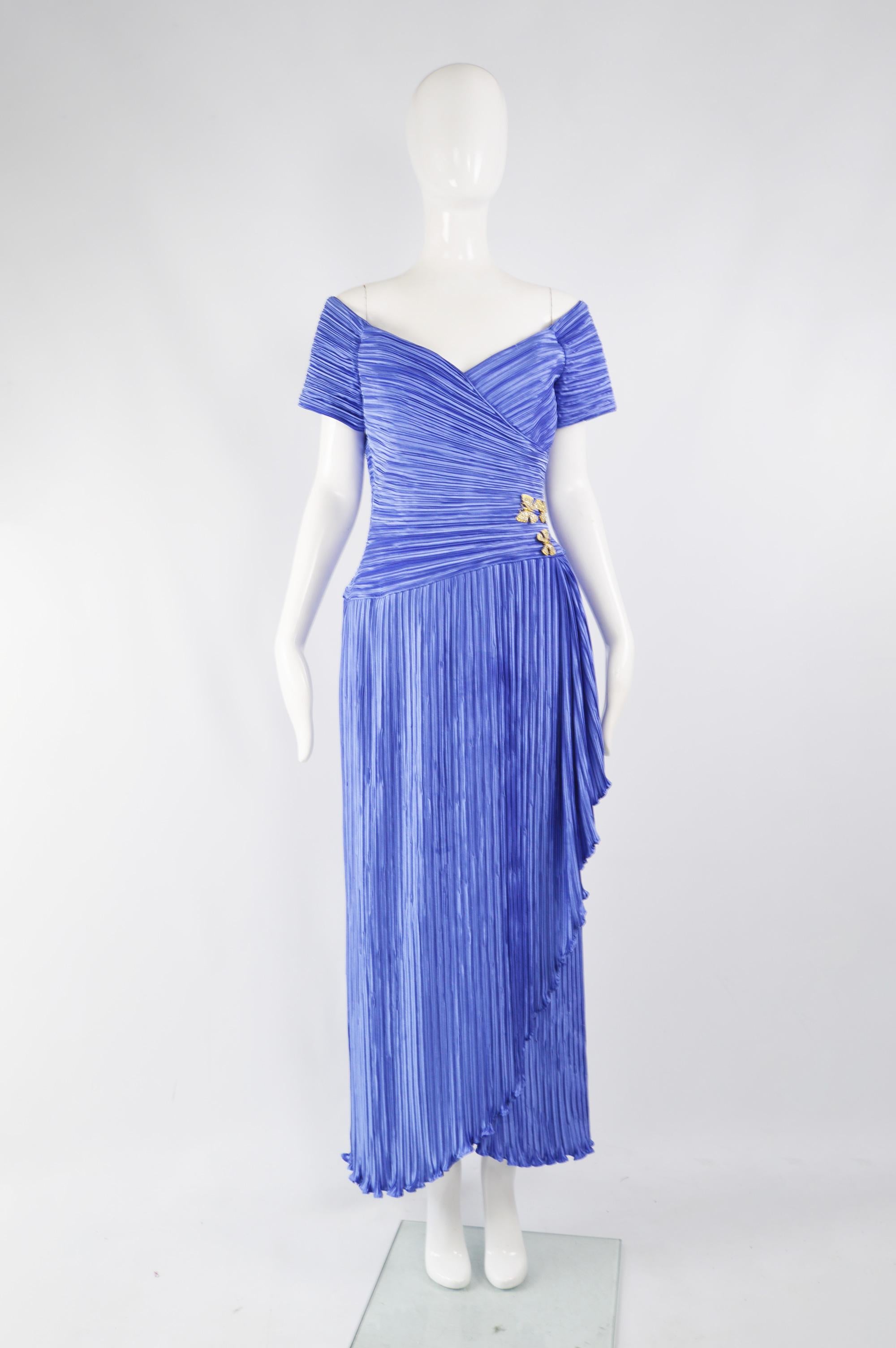 A fabulous vintage off the shoulder evening gown from the 80s by luxury American fashion label, George F. Couture. In a blue fortuny pleated fabric, embellished with gold butterflies and gathers at the side. Perfect for a formal party or red carpet