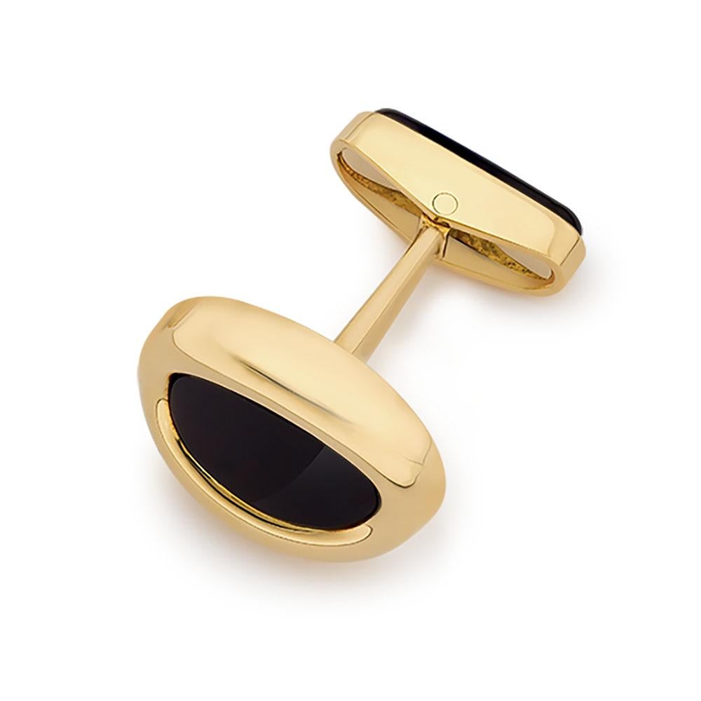 Classic and traditional ,these oval cuff links are timeless. The oval shaped cuff links have Black Onyx  centers and are set in polished 18 kt. yellow gold. The cuff links measure 3/4