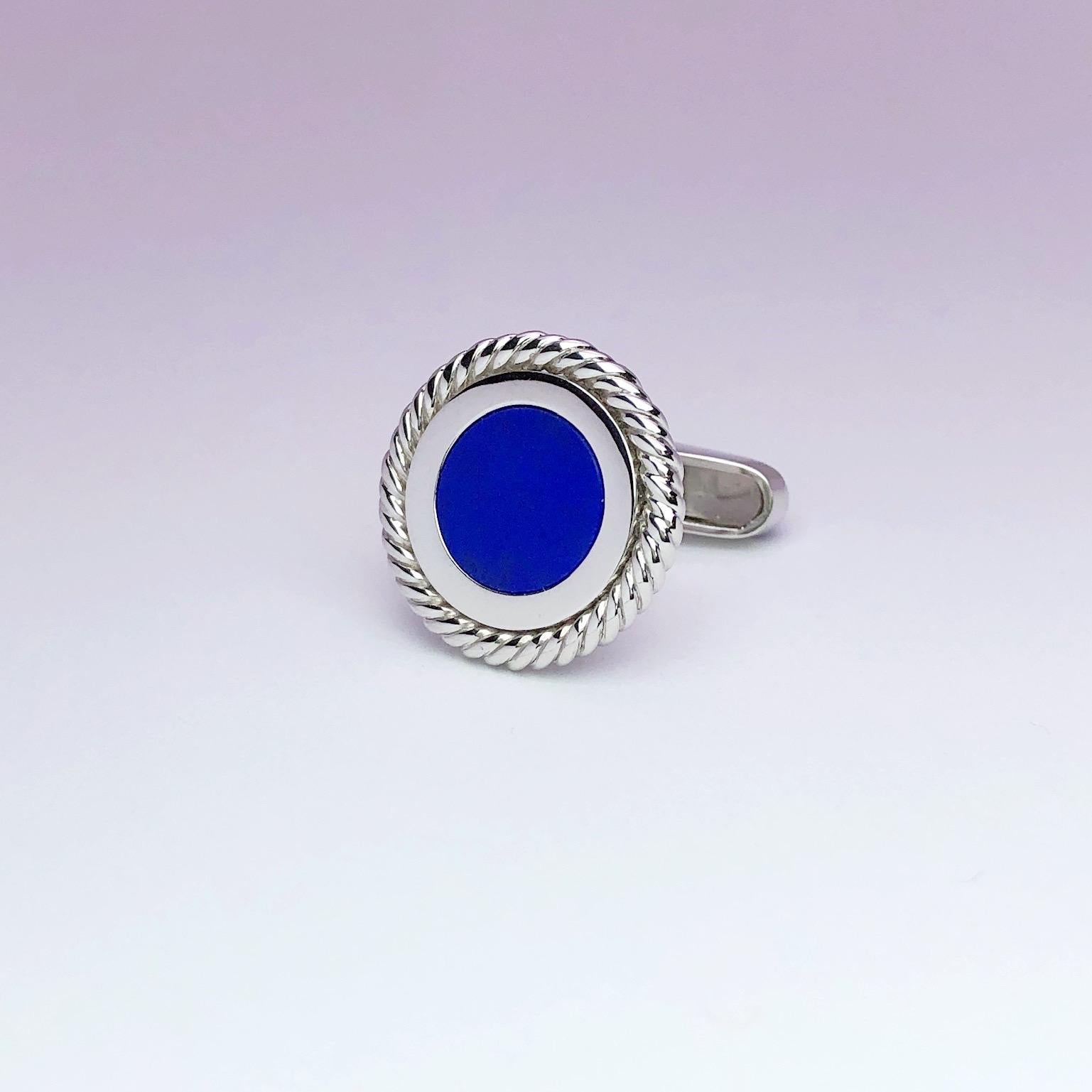 Created by George Gero, renowned worldwide for luxurious men's cuff-links, comes this classic  round pair which are set with lapis lazuli centers in a high polished 18 karat white gold braided bezel setting.
Cufflinks have collapsible backs set with