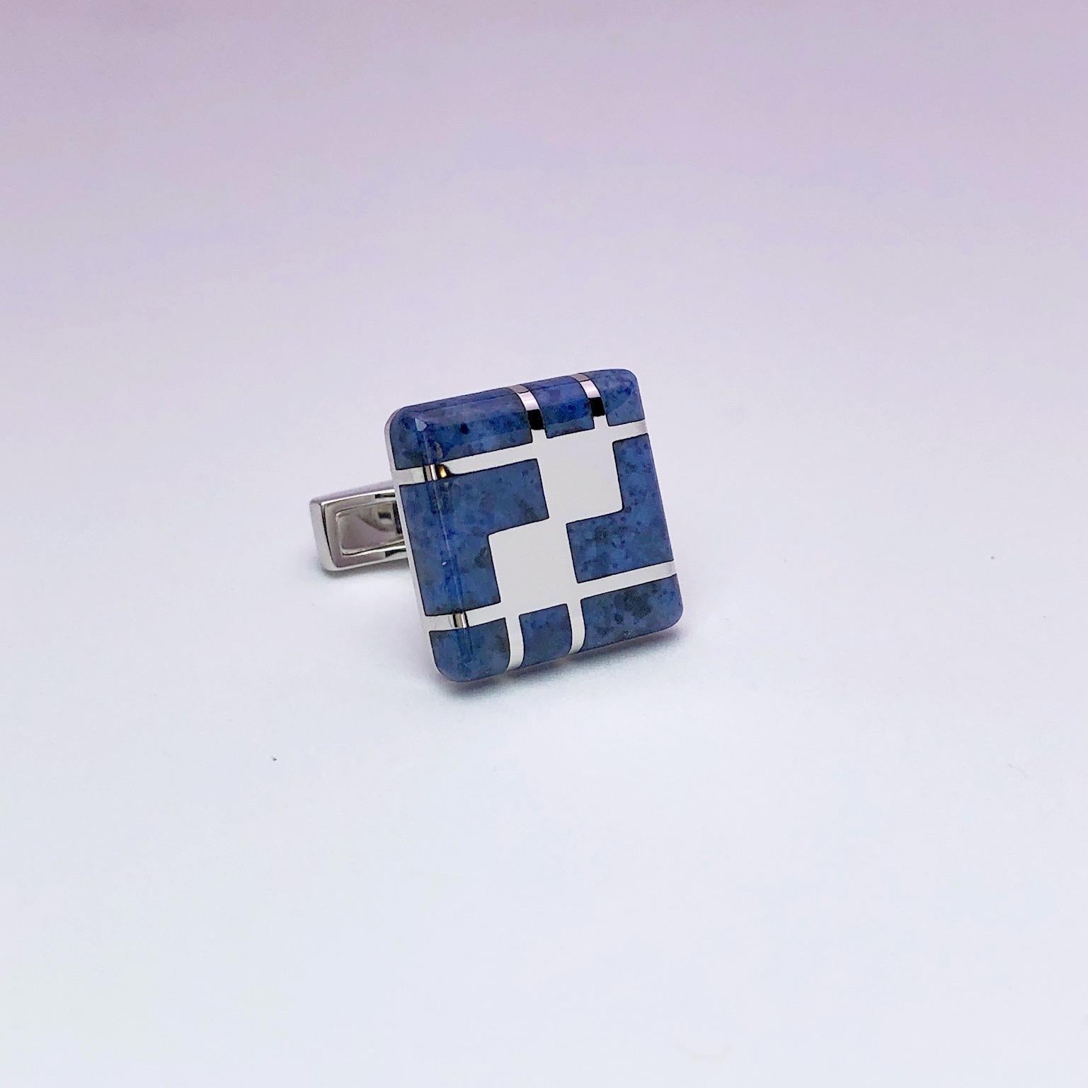 Created by George Gero, renowned worldwide for luxurious men's cuff-links, comes this classic  square shaped pair which are set in 18 karat white gold and blue dumortierite in a geometric pattern. Bar style cufflinks with collapsible backs.
The cuff