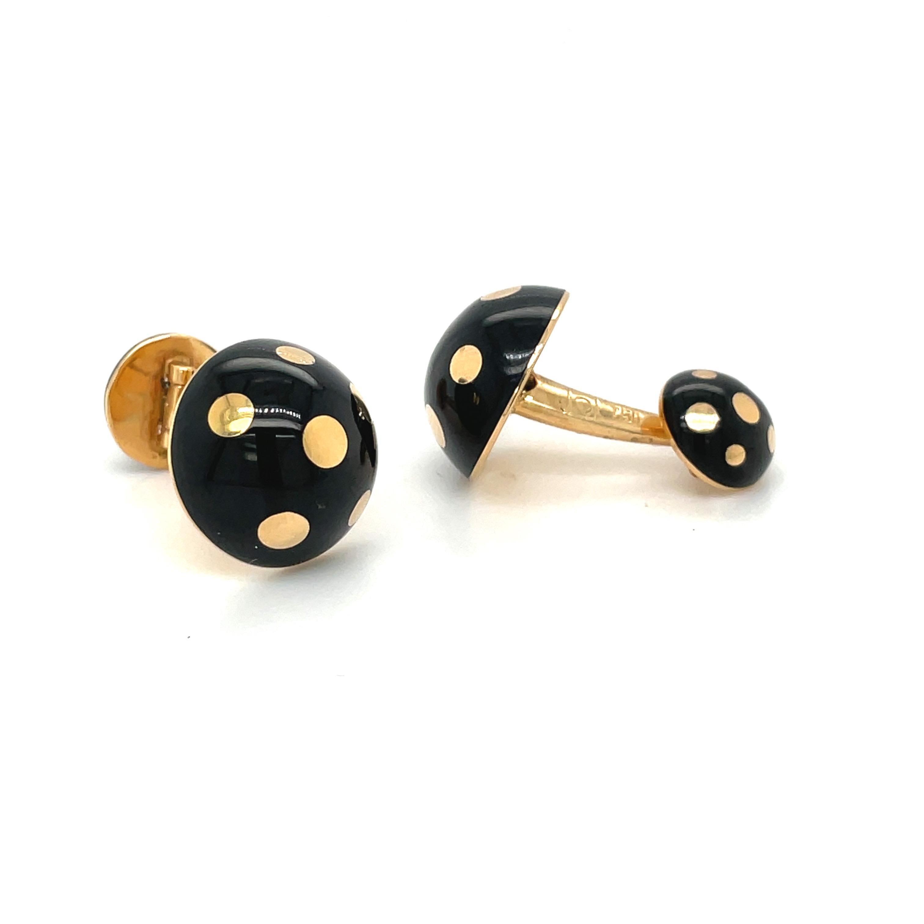 Created by George Gero, renowned worldwide for luxurious men's cuff-links, comes this classic round pair in 18 karat yellow gold. The half round cuff links are designed in black enamel with gold polka dots. They are bar style with a smaller half