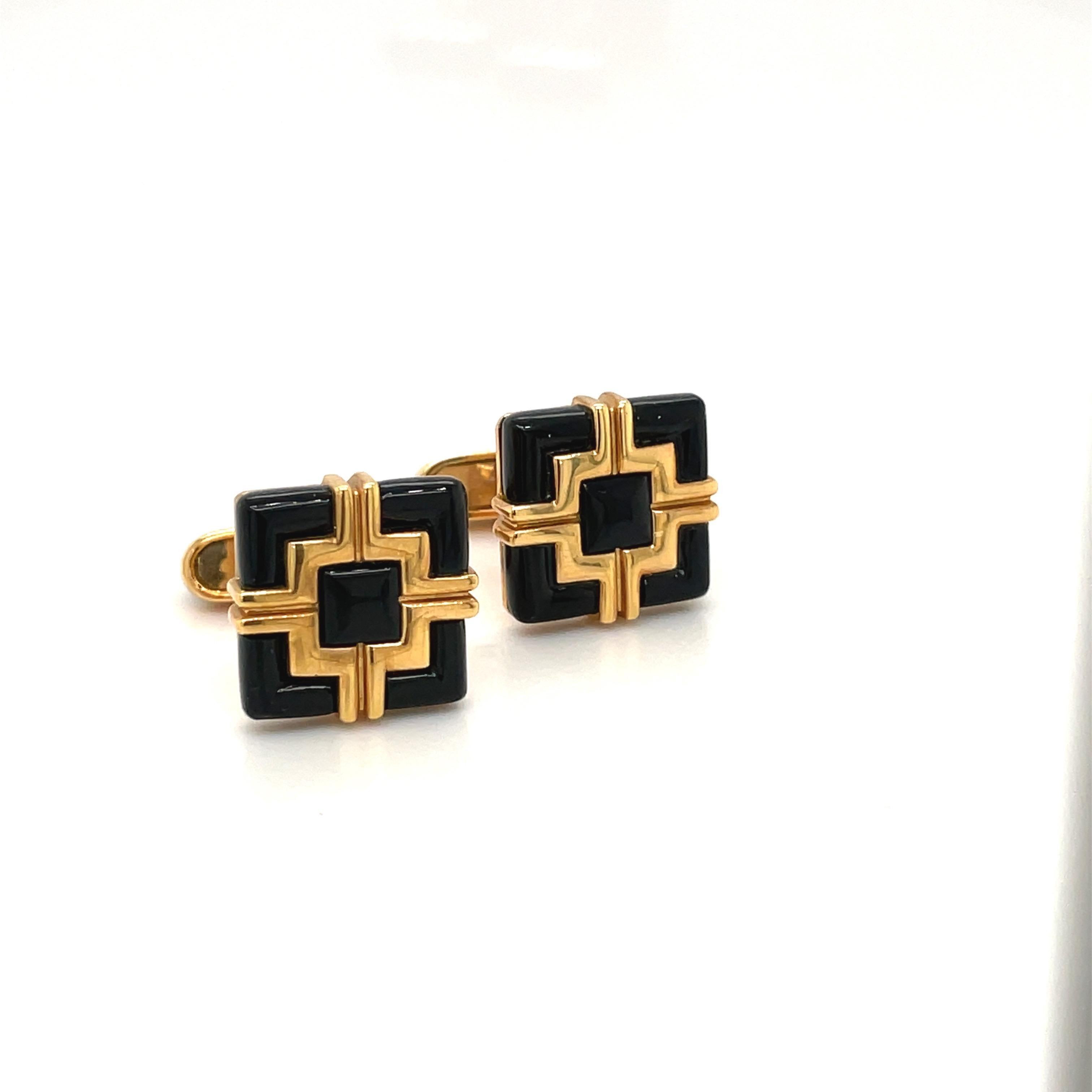 Created by George Gero, renowned worldwide for luxurious men's cuff-links, comes this classic pair in 18 karat yellow gold . The square geometric cuff links are set with black onyx and and yellow gold . They have a collapsible onyx bar style back