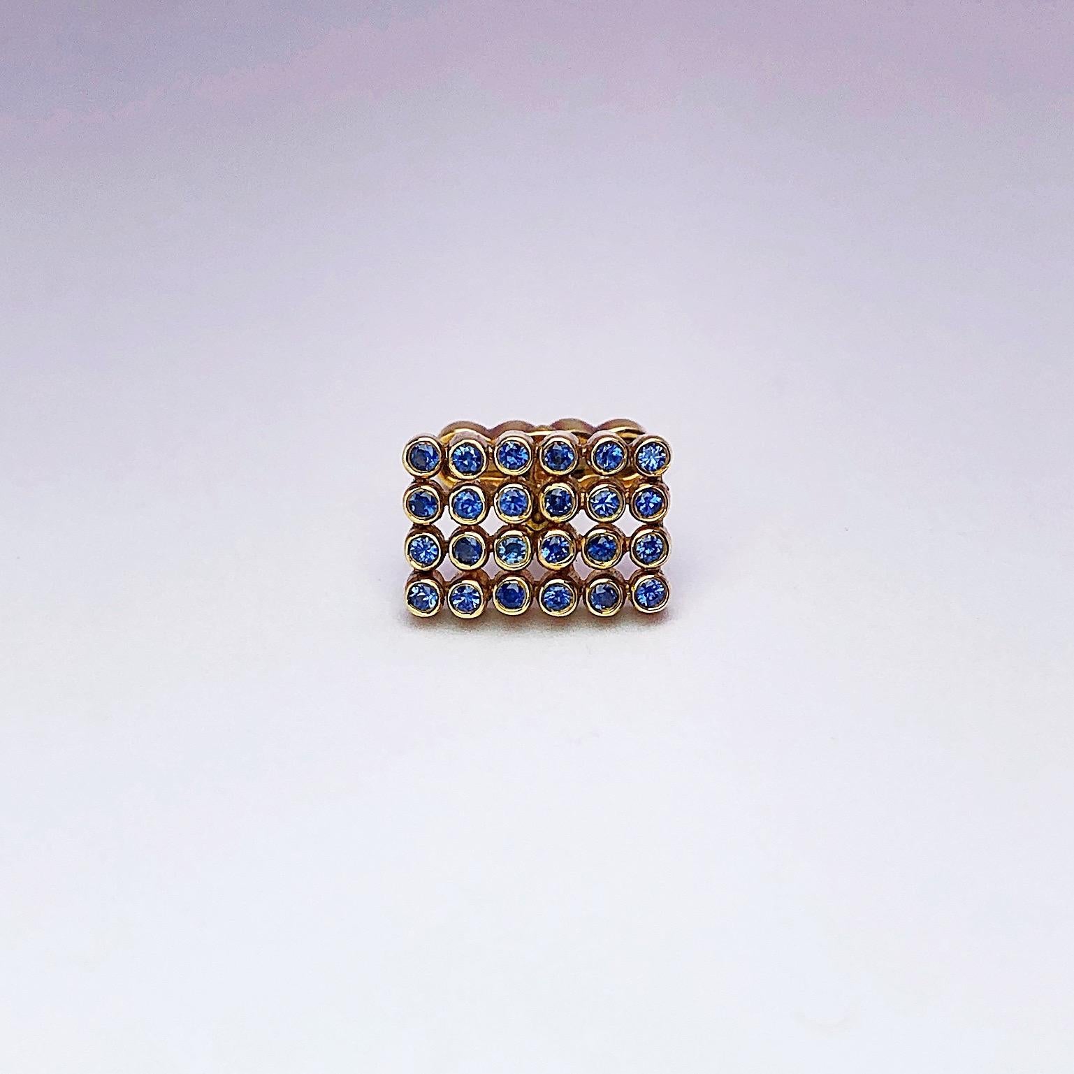 Created by George Gero ,renowned worldwide for luxurious men's cuff-links, comes this classic  rectangular shaped pair in 18 karat yellow gold with blue sapphires in tube settings. The collapsible backs are designed with four circles that mimic the