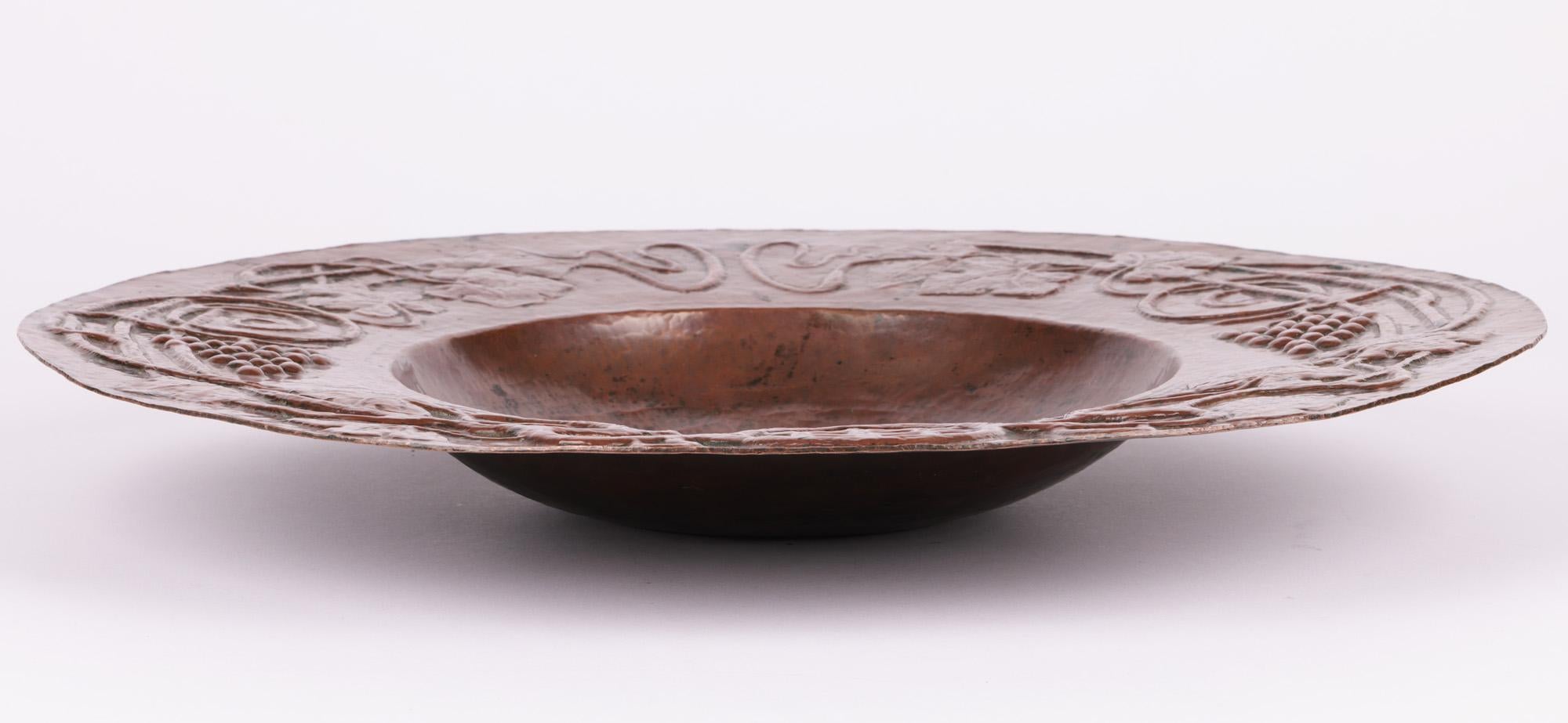 An exceptional and unique hand-crafted Arts & Crafts heavy large copper fruit bowl with molded fruiting vines by renowned artist George Hugo Tabor (British, 1857-1920) and dating from around 1880. 

George Hugo Tabor joined Doulton Lambeth in 1881