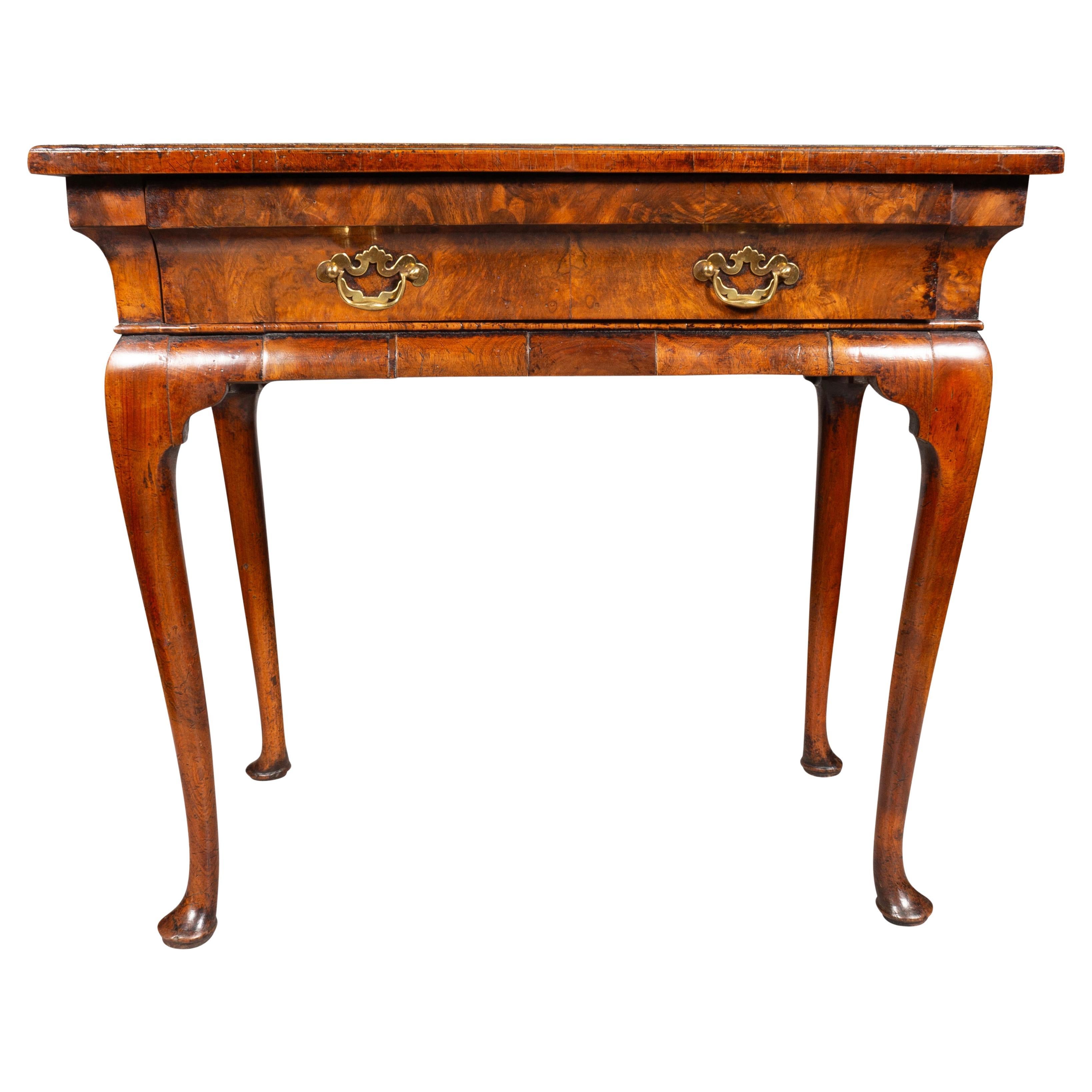 Rectangular burl wood top with crossbanded edge over shaped frieze with a conforming  drawer with two brass handles. Cabriole legs and pad feet. Provenance; Florian Papp. Sold 28,000 in 2000.
