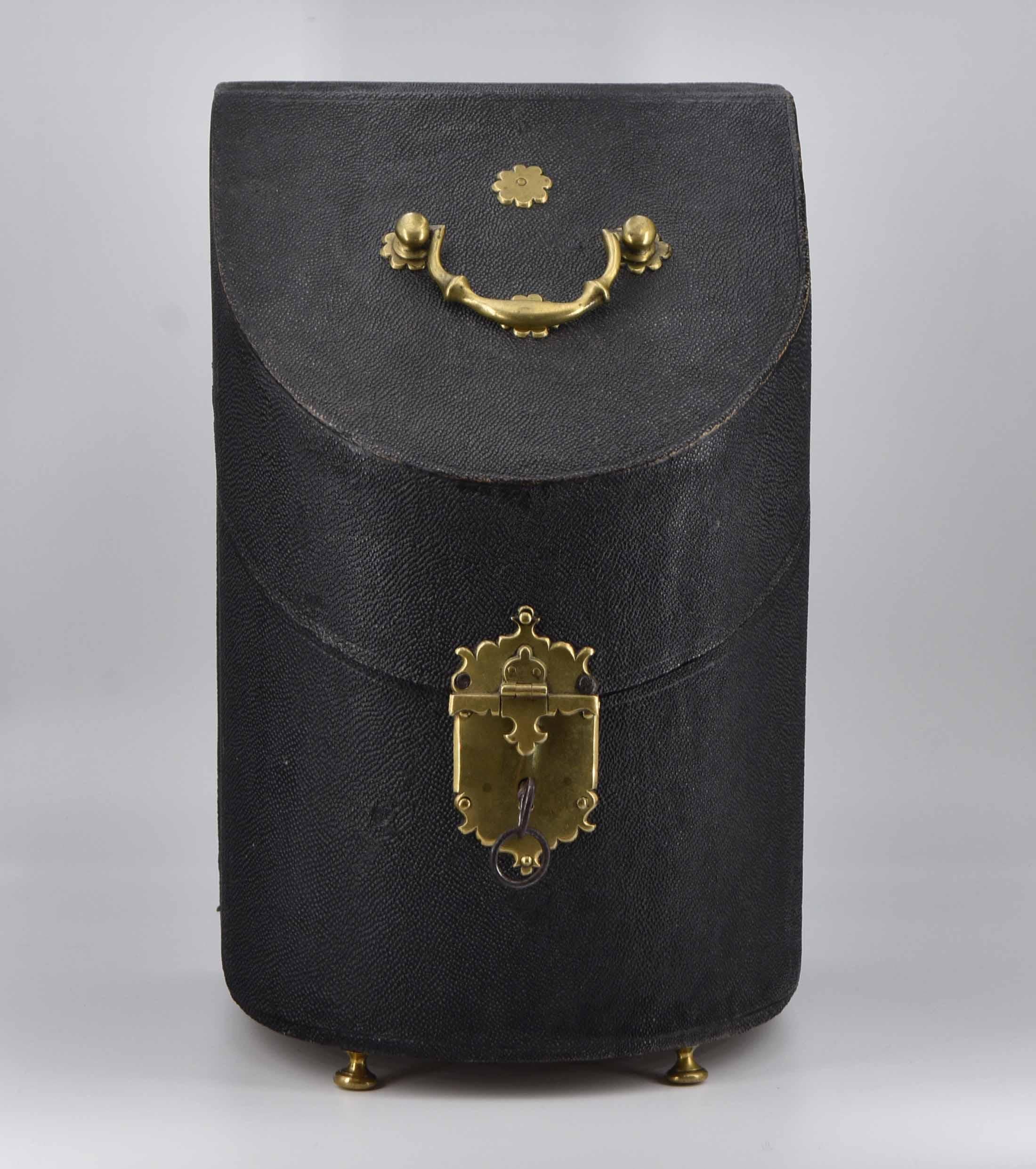 A George II shagreen knife box of bow fronted form, with brass clasp, feet and handle. The interior fitted in red velvet. Circa 1740-1760.

The knife box became a symbol of importance in early dining rooms, since owning silver, including knives,