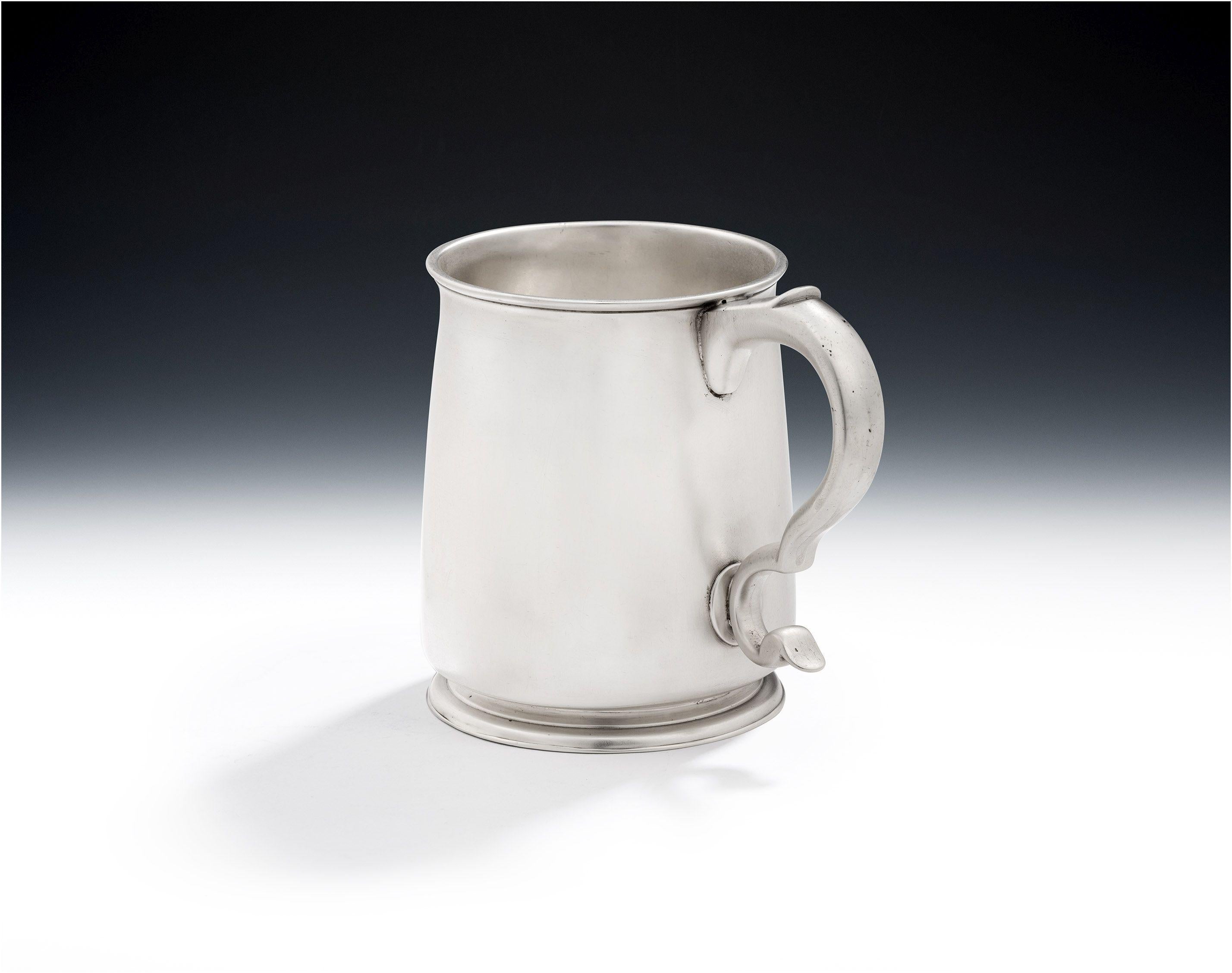 A Very Fine George I Pint Mug Made in London in 1721 by Thomas Folkingham.

The Mug has slightly tapering sides, a tucked in base, and everted rim, which was the style of the 1720's and 1730's.  This example has a very attractive scroll handle and