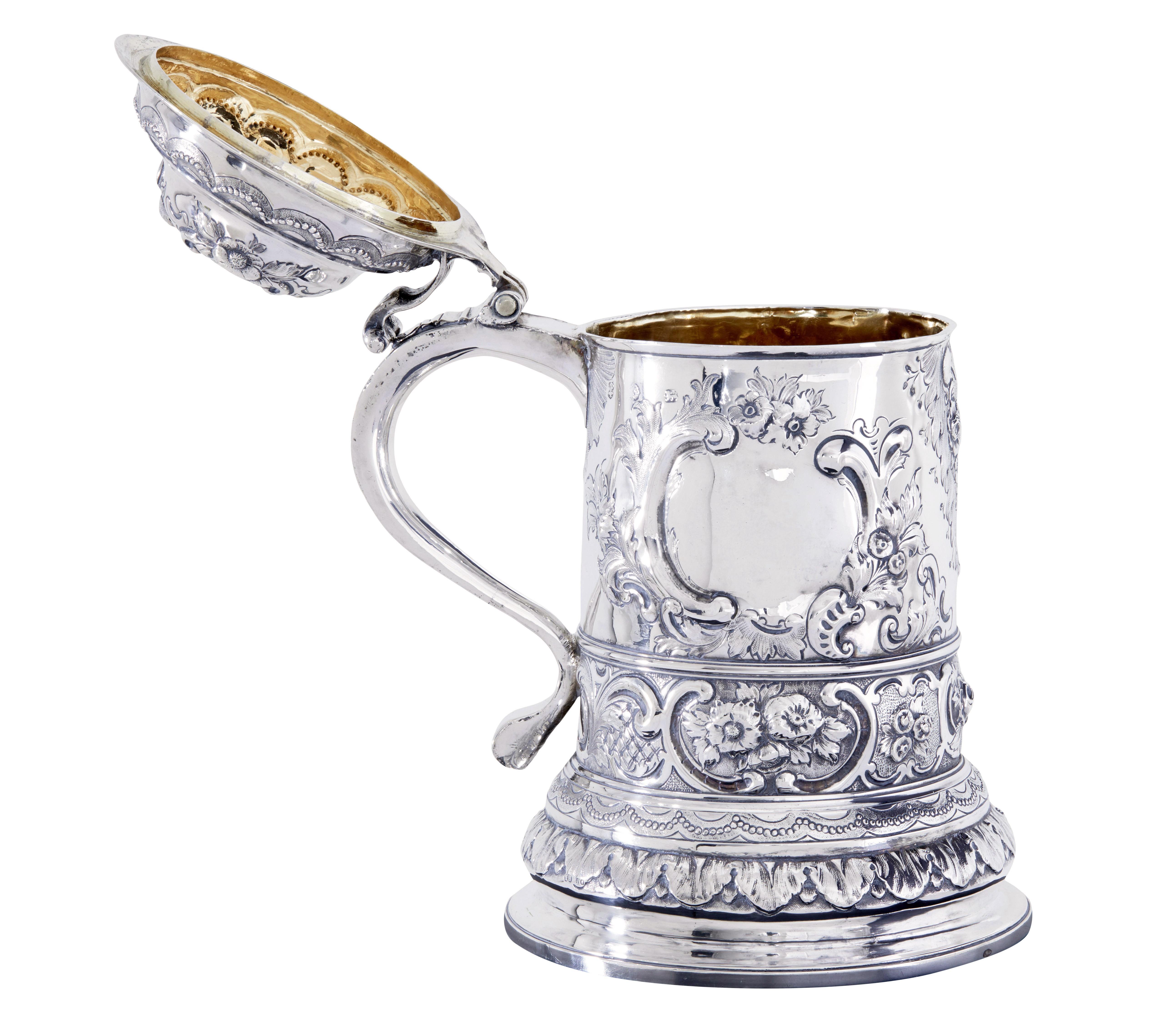 John Penfold (aka penford) makers mark rococo silver lidded tankard, circa 1723.

Here we have a beautiful silver lidded tankard in the rococo style.  The interior is gilded and

Overall condition is good.

The tankard bears exterior and interior