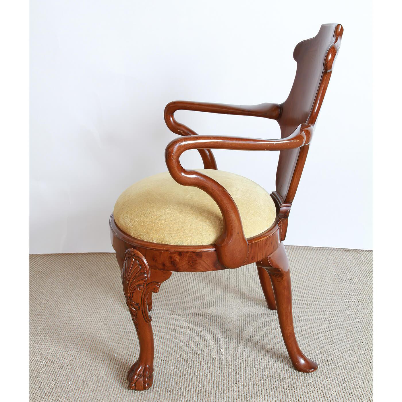 An unusual English George I style armchair with a curved splat and Shepard's crook arms, an oval inset upholstered seat with shell carved knees and bold ball and claw feet. ca 1940's.

Dimensions: 24.5