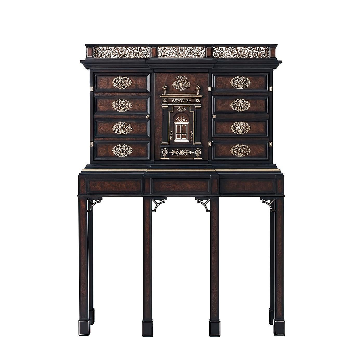 A mahogany, chestnut burl veneered, parcel gilt and finely brass decorated Bar cabinet, the pierced brass gallery top above two faux drawer fronted cabinet doors and centered by a further doors with a columned grand entrance with finely cast and