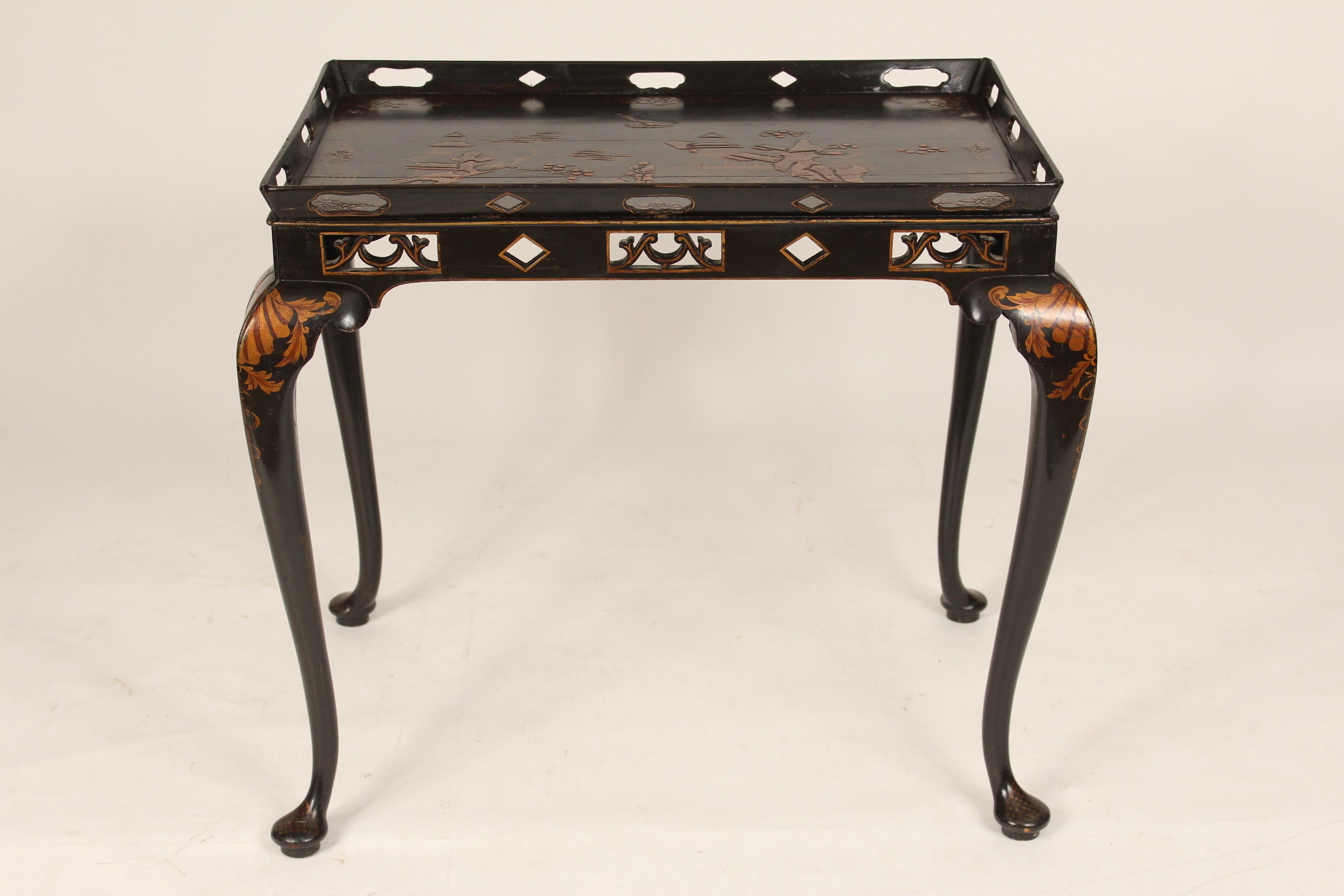 George I style black chinoiserie decorated occasional table, circa 1920. With a pierced gallery rim, raised chinoiserie decorations on the top and cabriole legs ending in pad feet. Either made in England or the U.S. Height to top of gallery 28.25,
