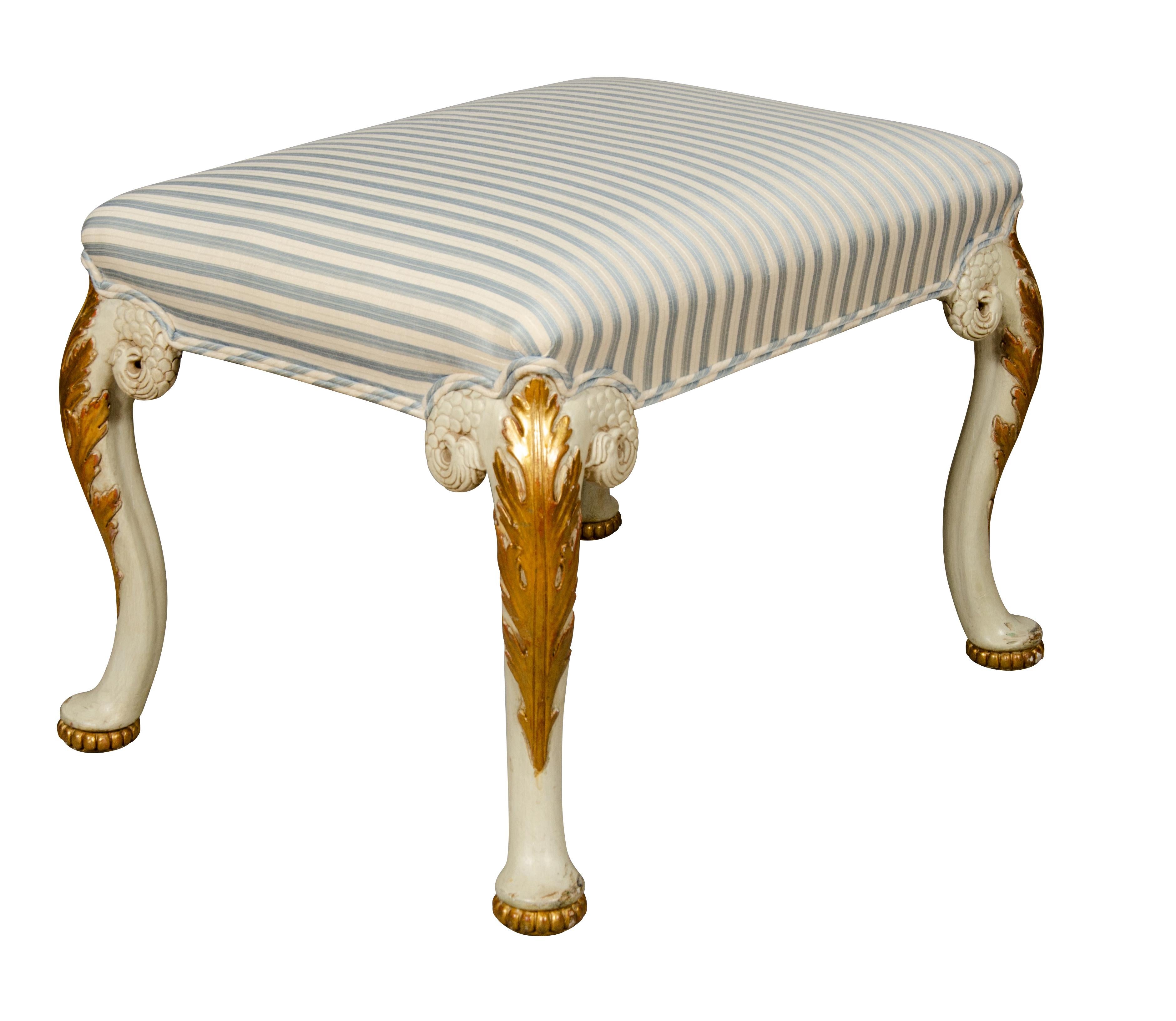 Rectangular upholstered top with cabriole legs with water gilded acanthus carved knees and ending on pad feet. From Mill House Antiques.