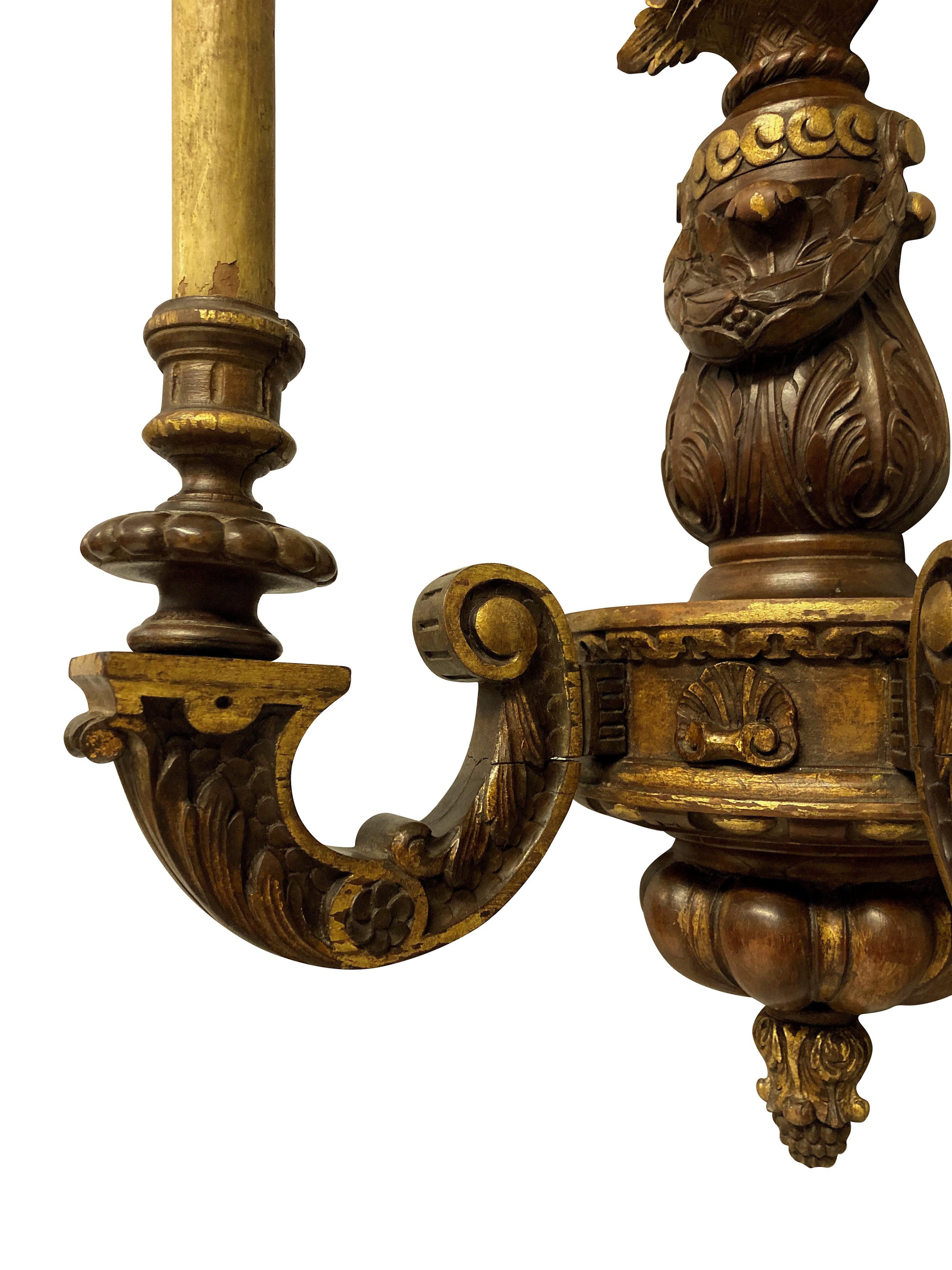 A George I style carved walnut and parcel gilt, twin branch wall light.