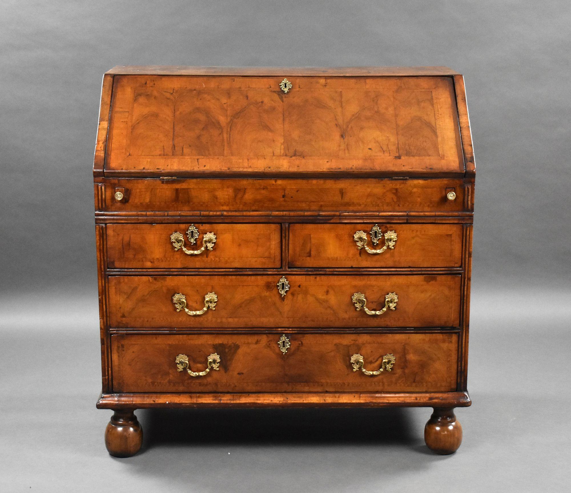 For sale is a good quality early 18th century George I walnut bureau, having a fall front opening to reveal a fully fitted interior comprising of drawers, pigeon holes, a well and a leather writing surface. Below this there is an arrangement of four