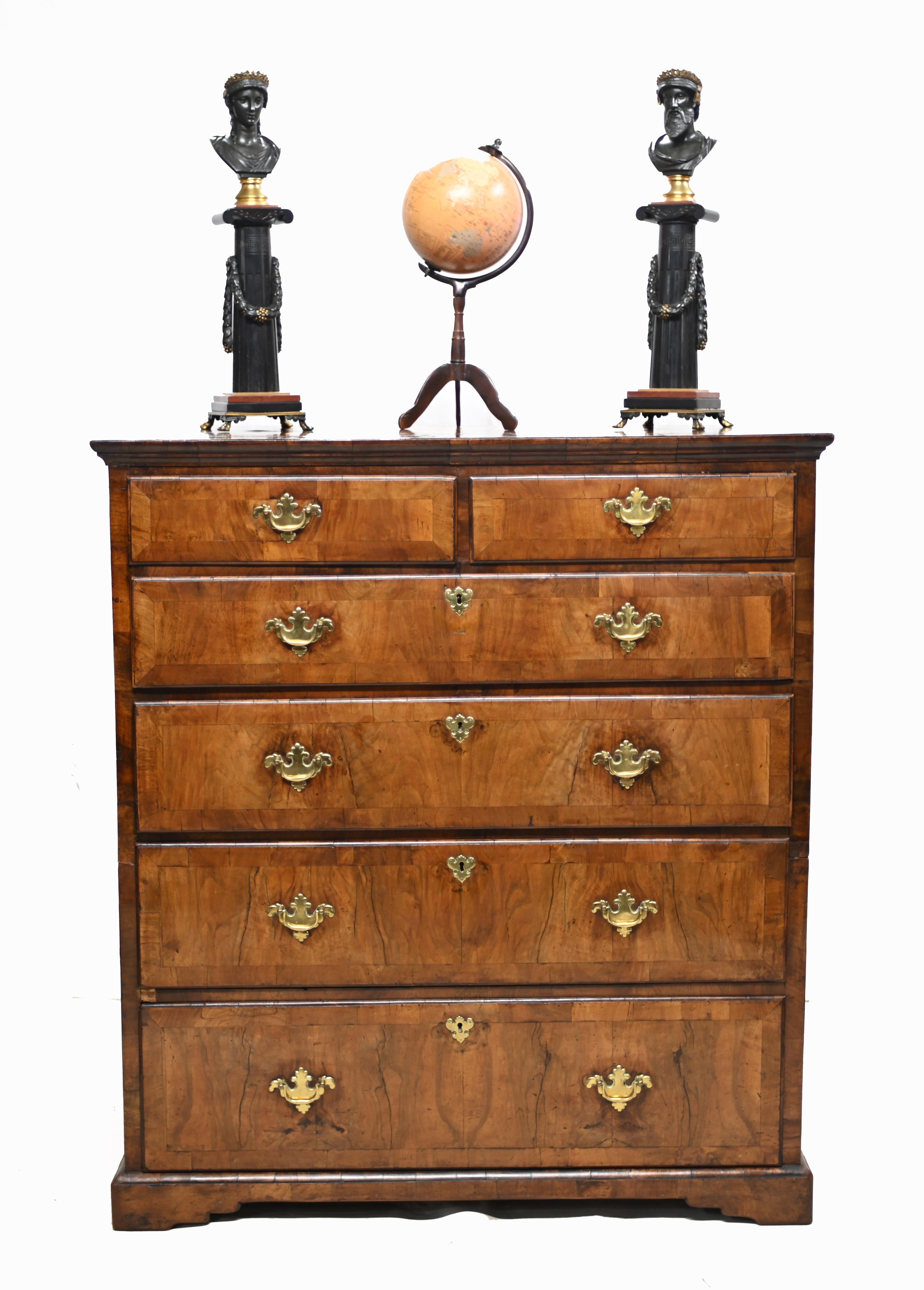 Stunning period George I walnut chest of drawers
The walnut chest is in two parts (this was common in the early days before the ease of carrying larger items to uptairs bedrooms through narrow stairways)
This particular chests is crossbranded in