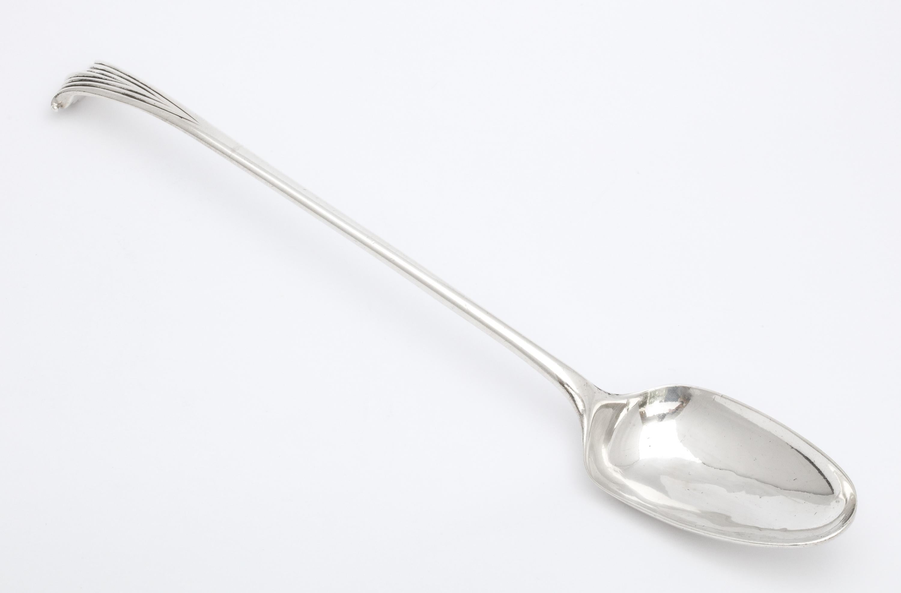 George II, Onslow pattern, sterling silver stuffing spoon, London, year hallmarked for 1745, Thomas Dene - maker. Measures 10 1/2 inches long x over 1 3/4 inches deep (at deepest point) x 1 1/2 inches high (when lying flat). Dark spots on silver in