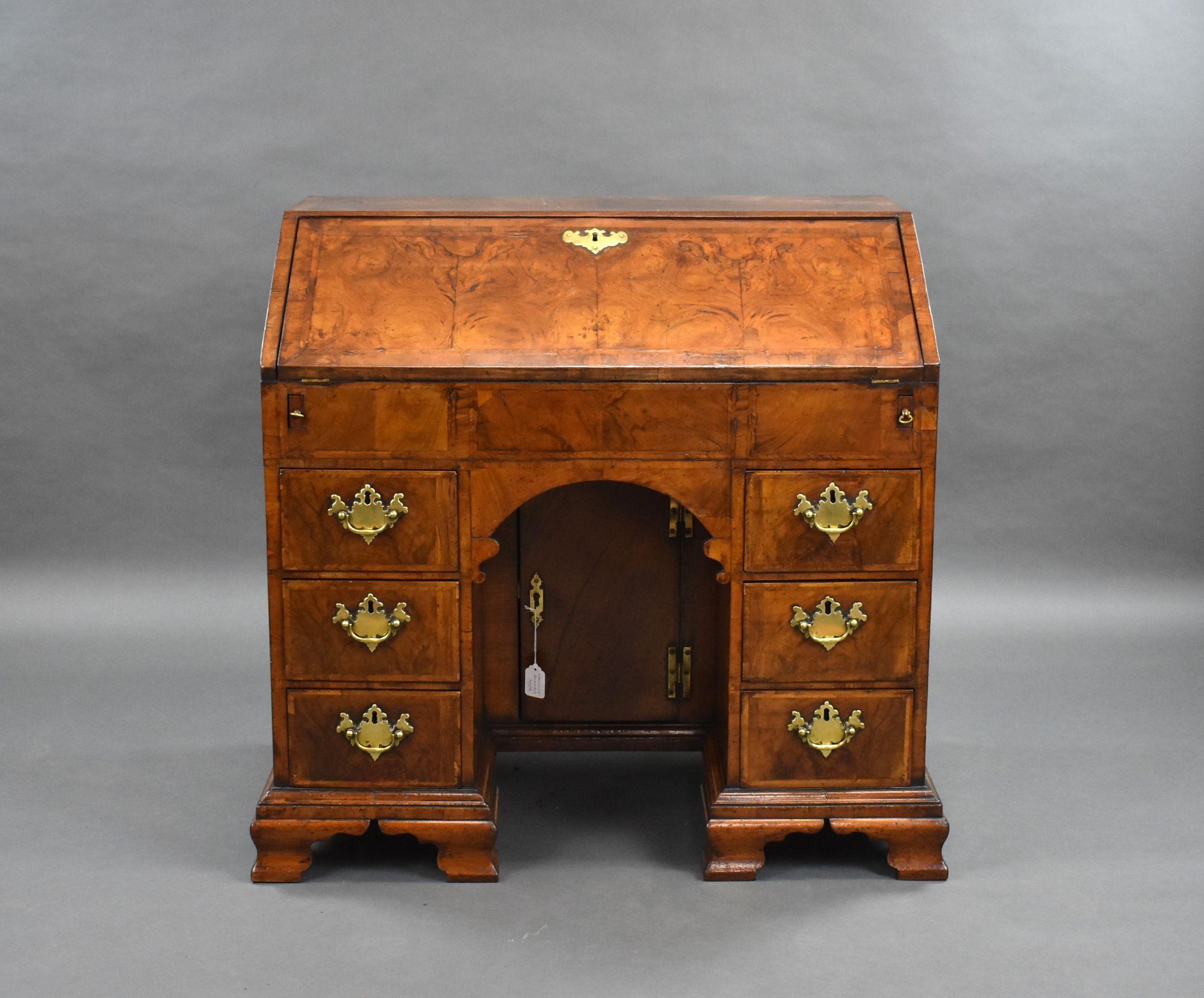 For sale is a good quality George II burr walnut bureau, cross and feather banded throughout, the fall opens to a fully fitted interior of drawers and pigeon holes, including four secret drawers, above a slide topped well and a gilt tooled green