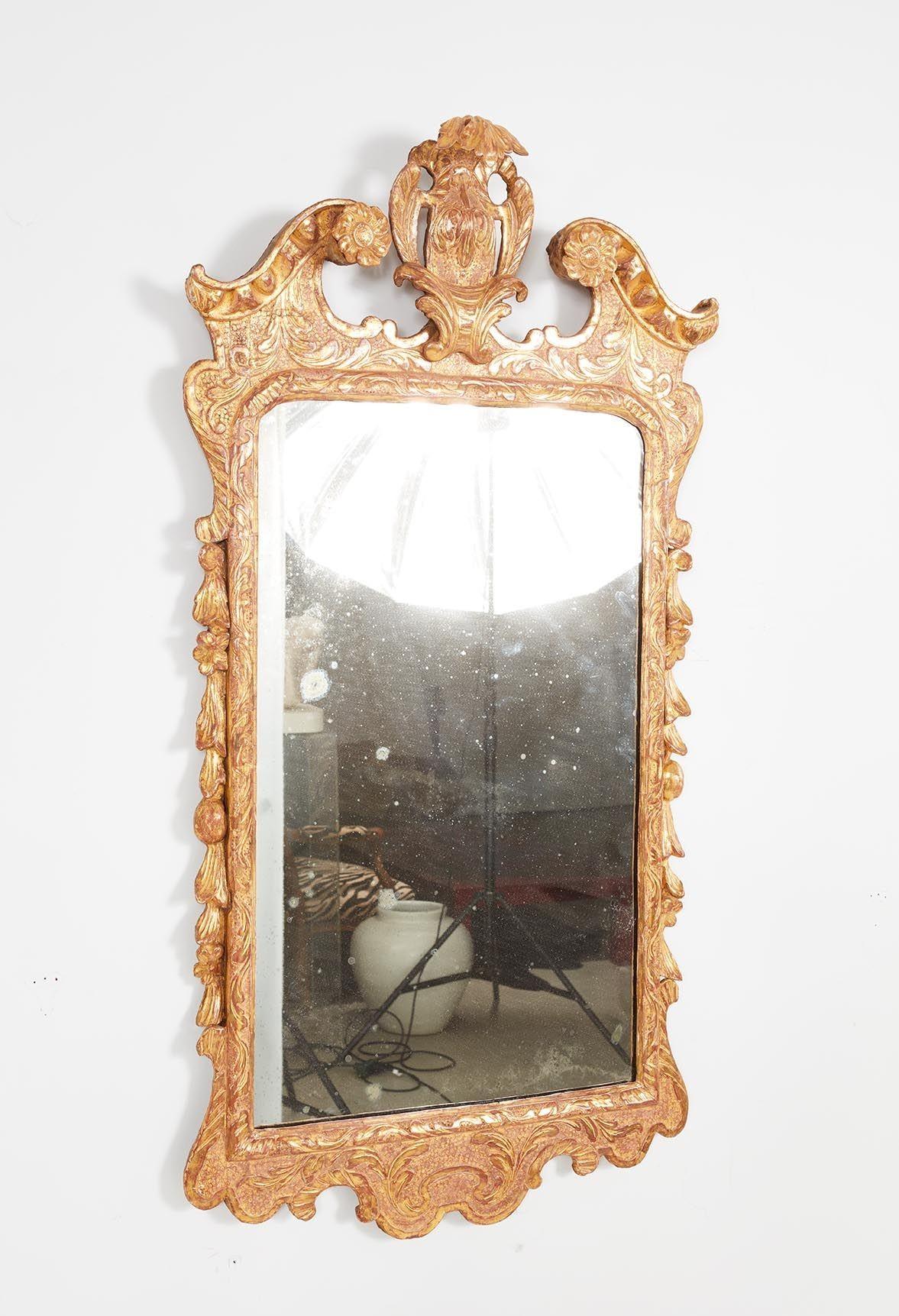 Good George II carved wood and gilt gesso mirror, the central cartouche flanked by swan neck pediment having egg and dart carved molded edge, the body with foliate relief carving on a punched ground, the sides with garland drops with leaves, fruit