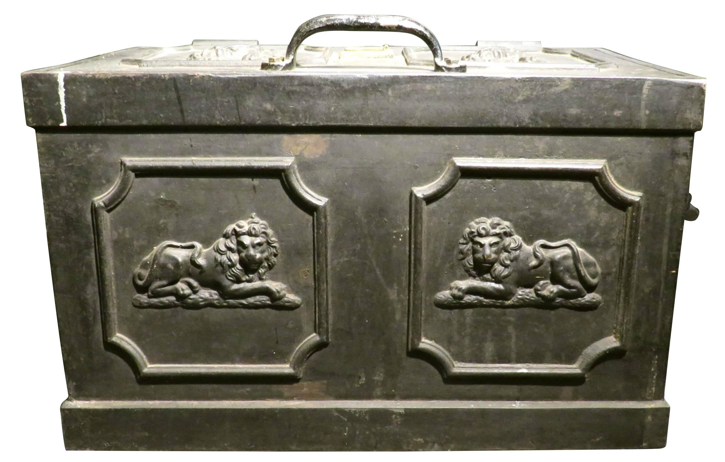 The top, sides and ends decorated with recumbent lions cast in high relief framed within raised mouldings, the sides fitted with swing handles, the top having a bar handle and a hinged brass keyhole-plate covering a functioning lock mechanism,