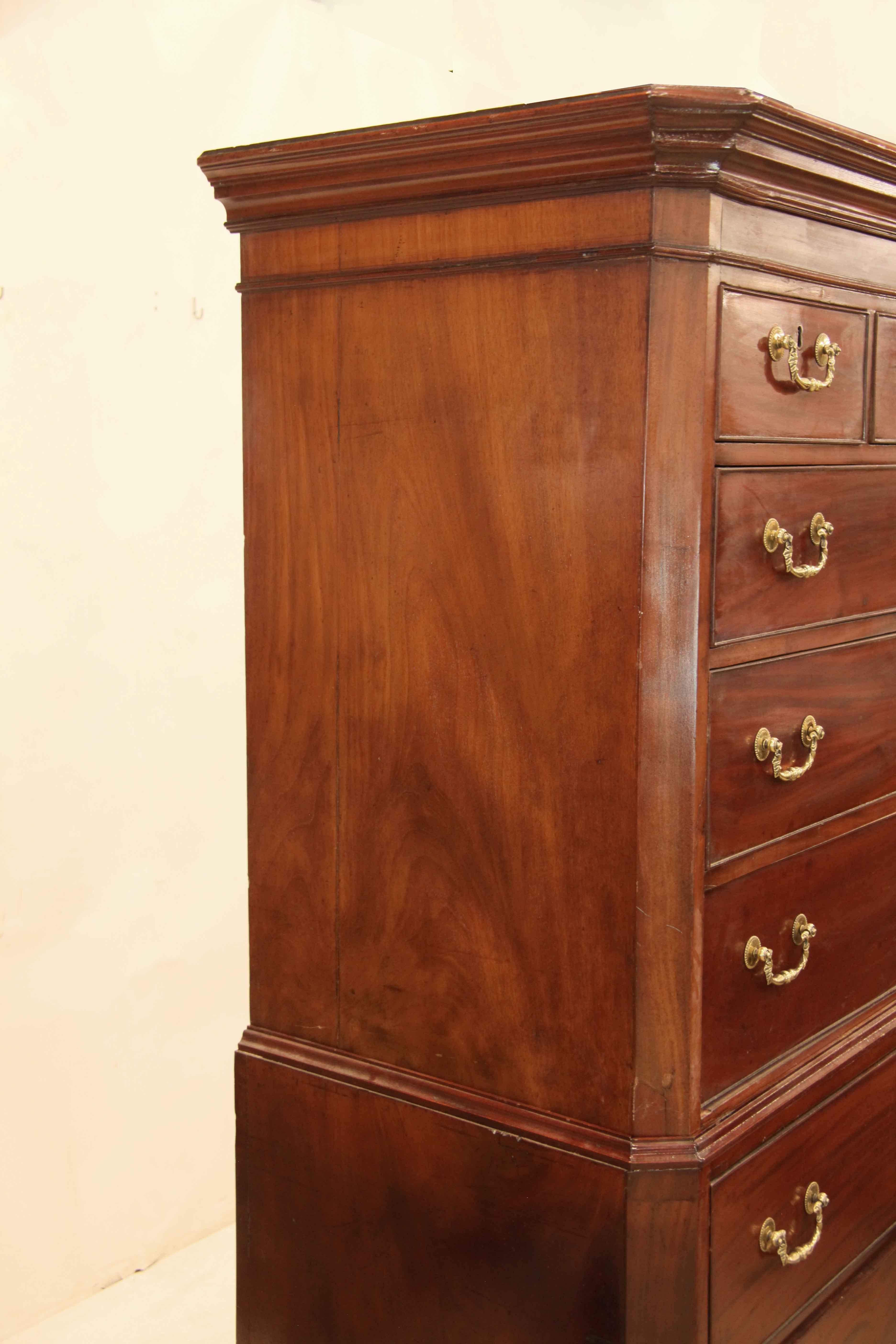 George II chest on chest, with bold cove cornice above bead molding;  the top has three over three graduated drawers, the bottom with three straight graduated drawers.  The ornate bail pulls are original.  This chest has multiple features worthy of
