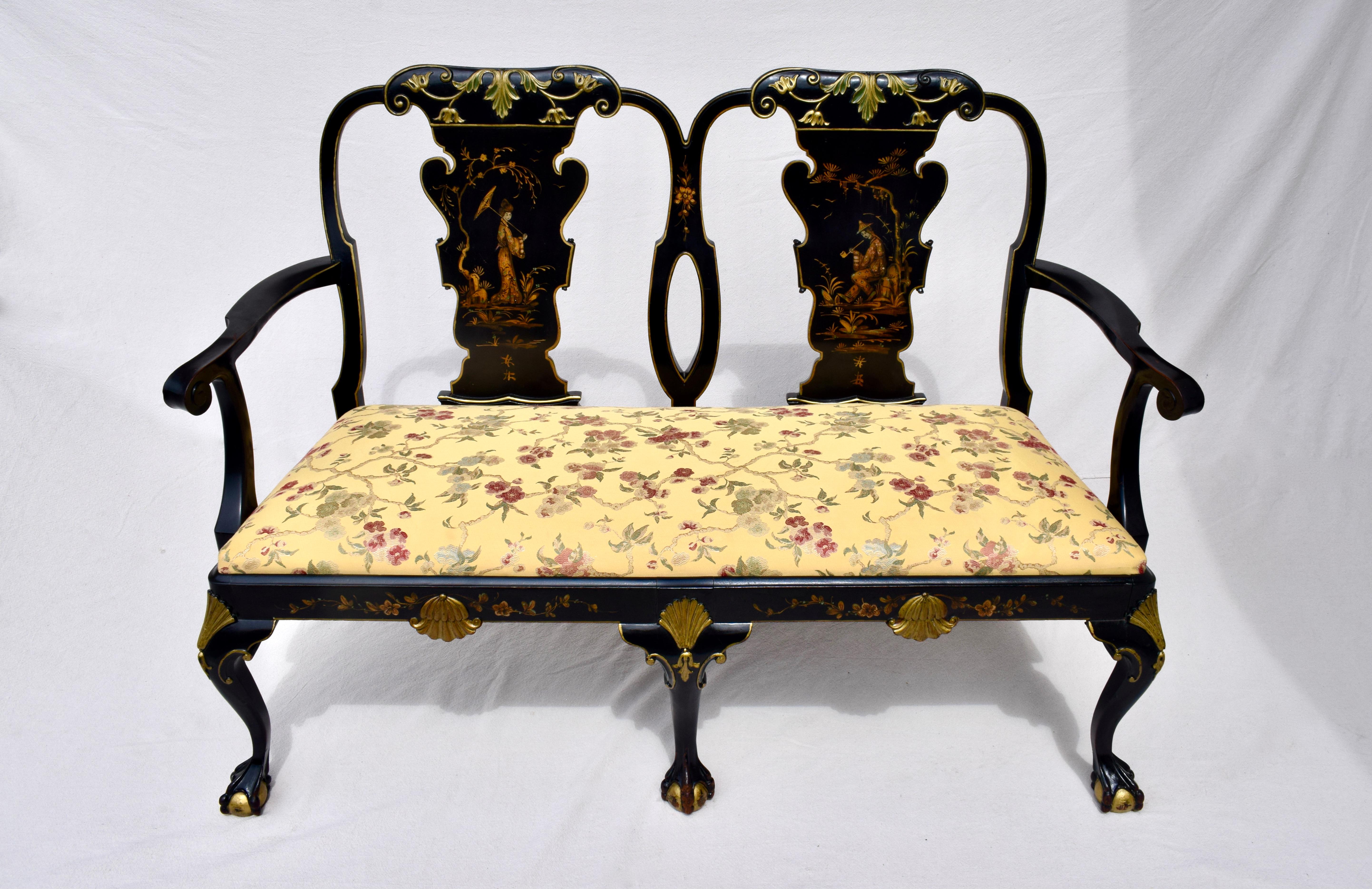 An early 20th c. George II style solid mahogany settee decorated with japan-work, chinoiserie landscapes and figures, on cabriole legs with ball and paw feet. Overall high quality japanning on black lacquered ground with carved relief shell