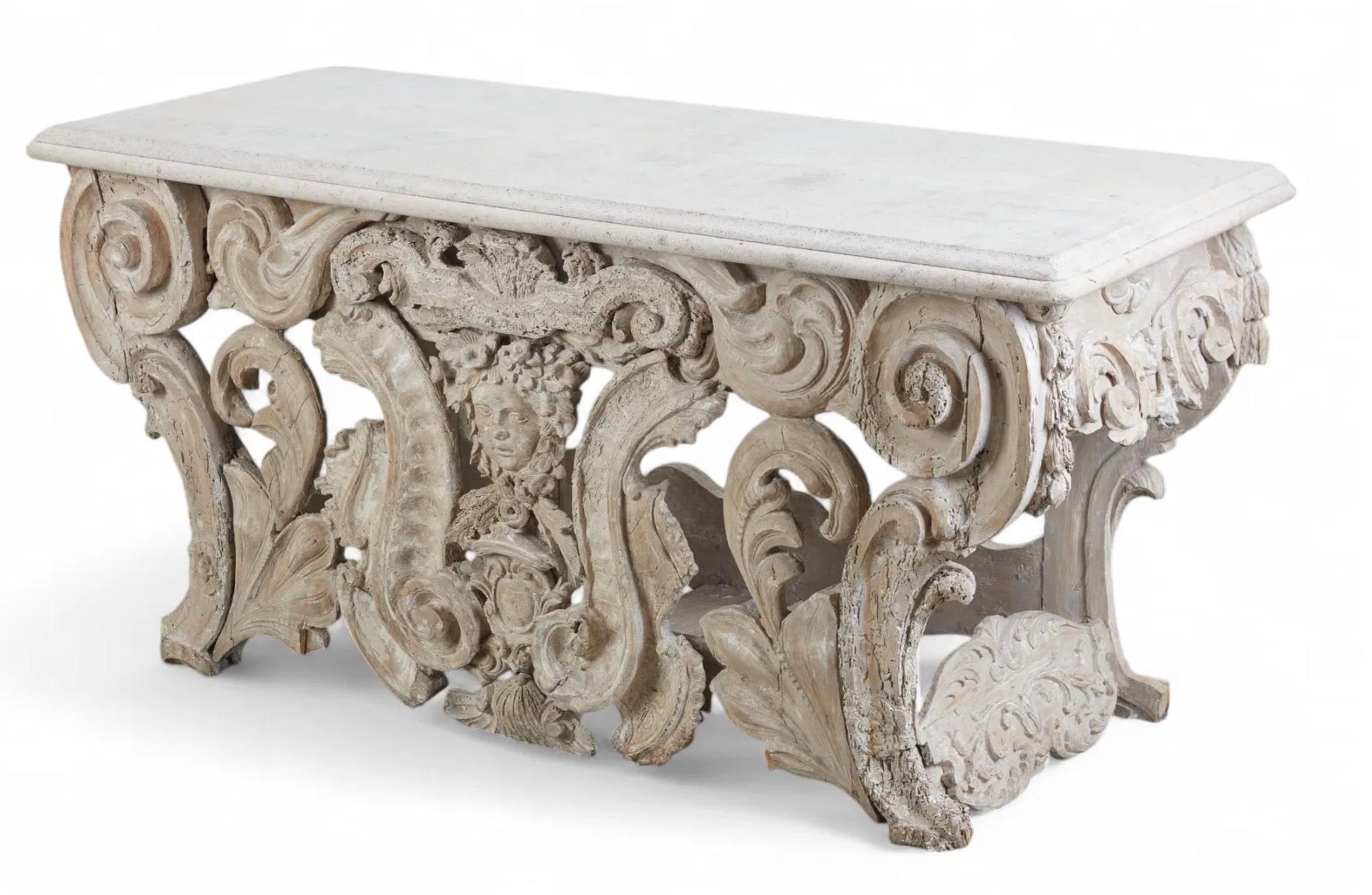 A George II style white painted console table
composed of antique and later elements
With faux marble top and later stone top.

