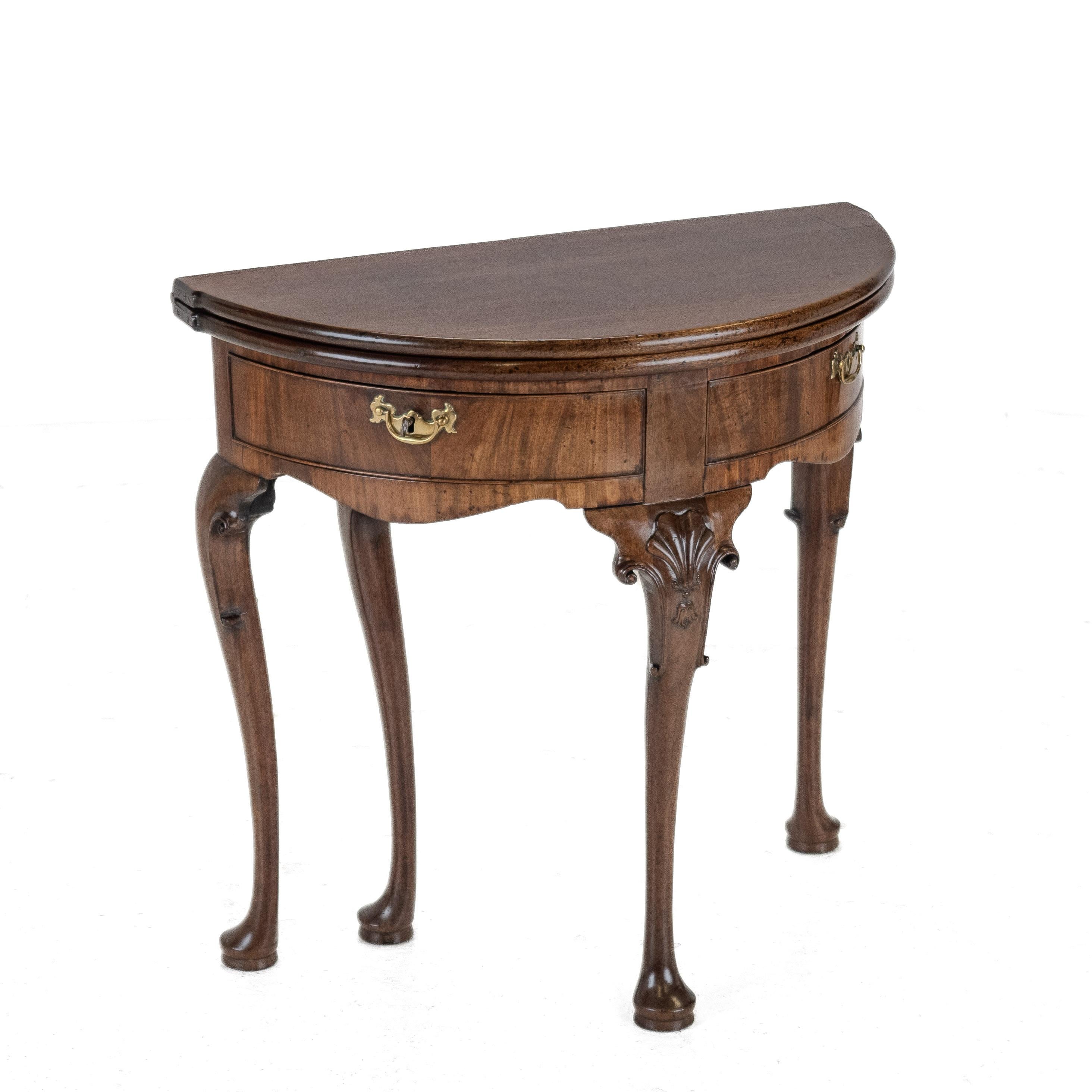 George II Cuban Mahogany Demi-Lune Fold-Over Tea Table with Twin Swing-Out Drawers, c.1750

A fine mid-18th century George II demi-lune fold-over tea table in richly figured Cuban mahogany, dating from around 1750.
Beautifully proportioned and