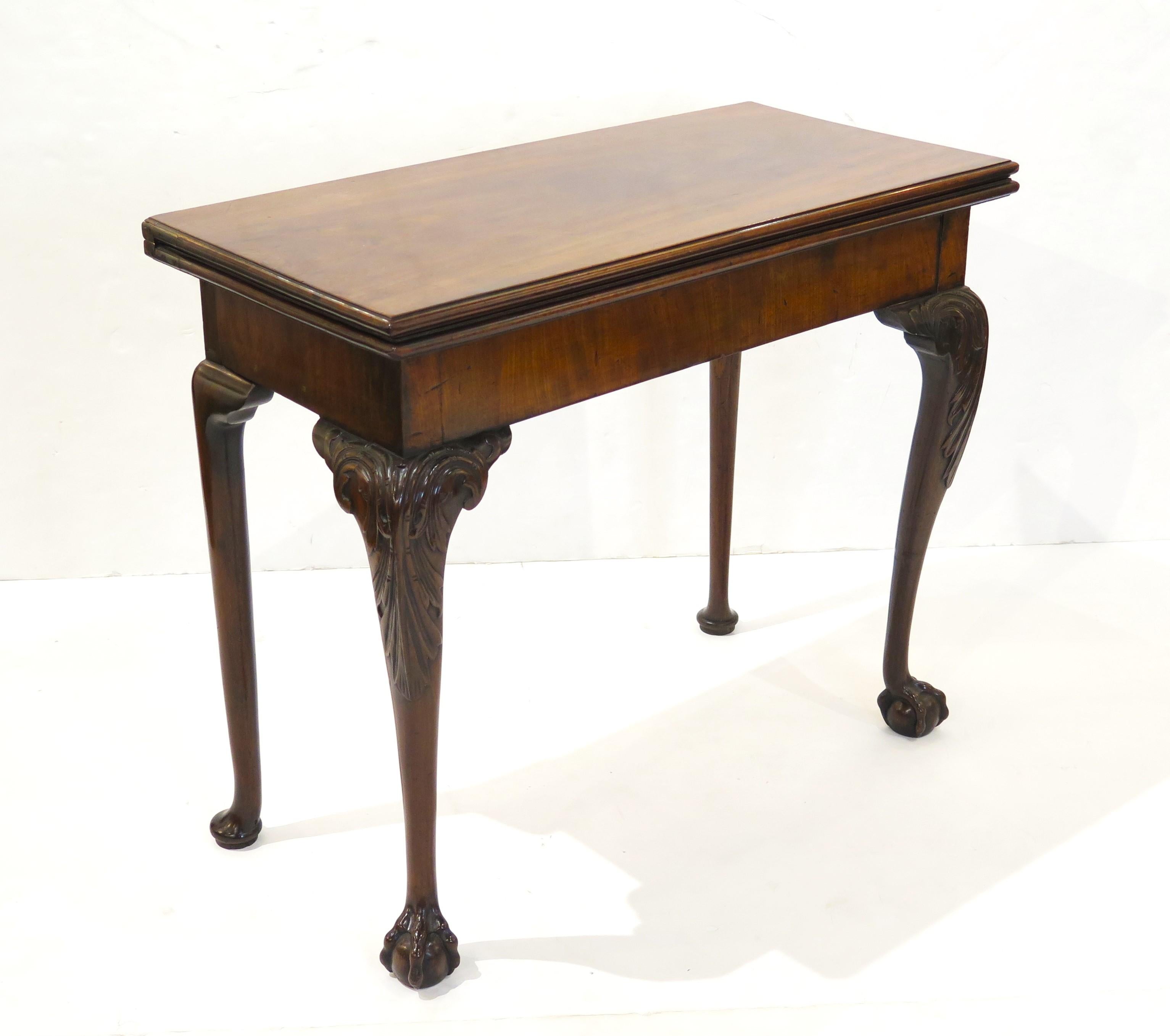 George II mahogany games / tea table with elegant hand-carved cabriole legs with beautiful carved knees and ball and claw feet (front legs), hinged back legs (more plain with pad feet) fold out to support top, concertina action, sliding wood panel