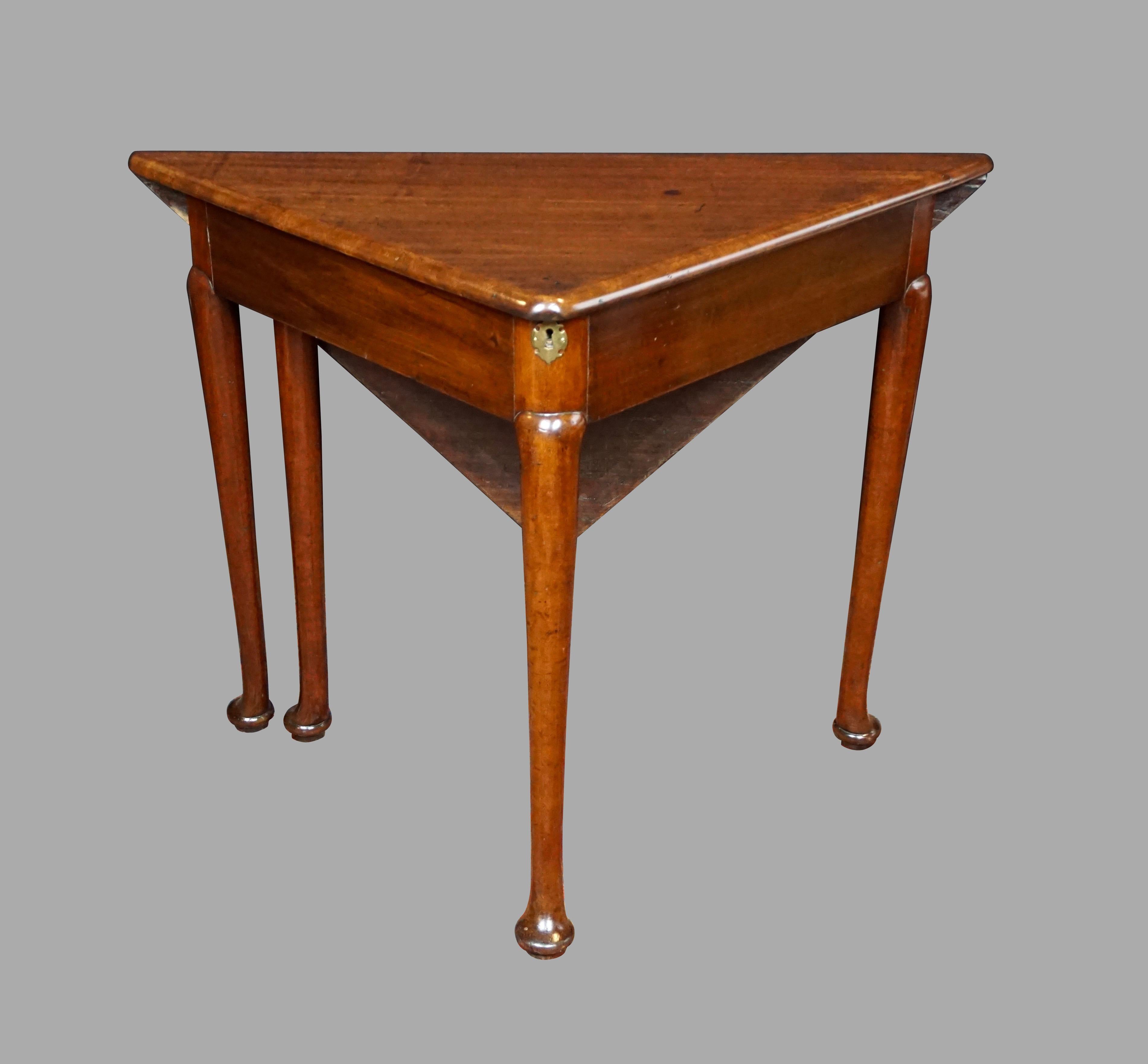 A pretty George II mahogany corner or envelope table with well, the square hinged top above a plain frieze with gateleg support resting on shaped legs with pad feet. Circa 1750. Refinshed.