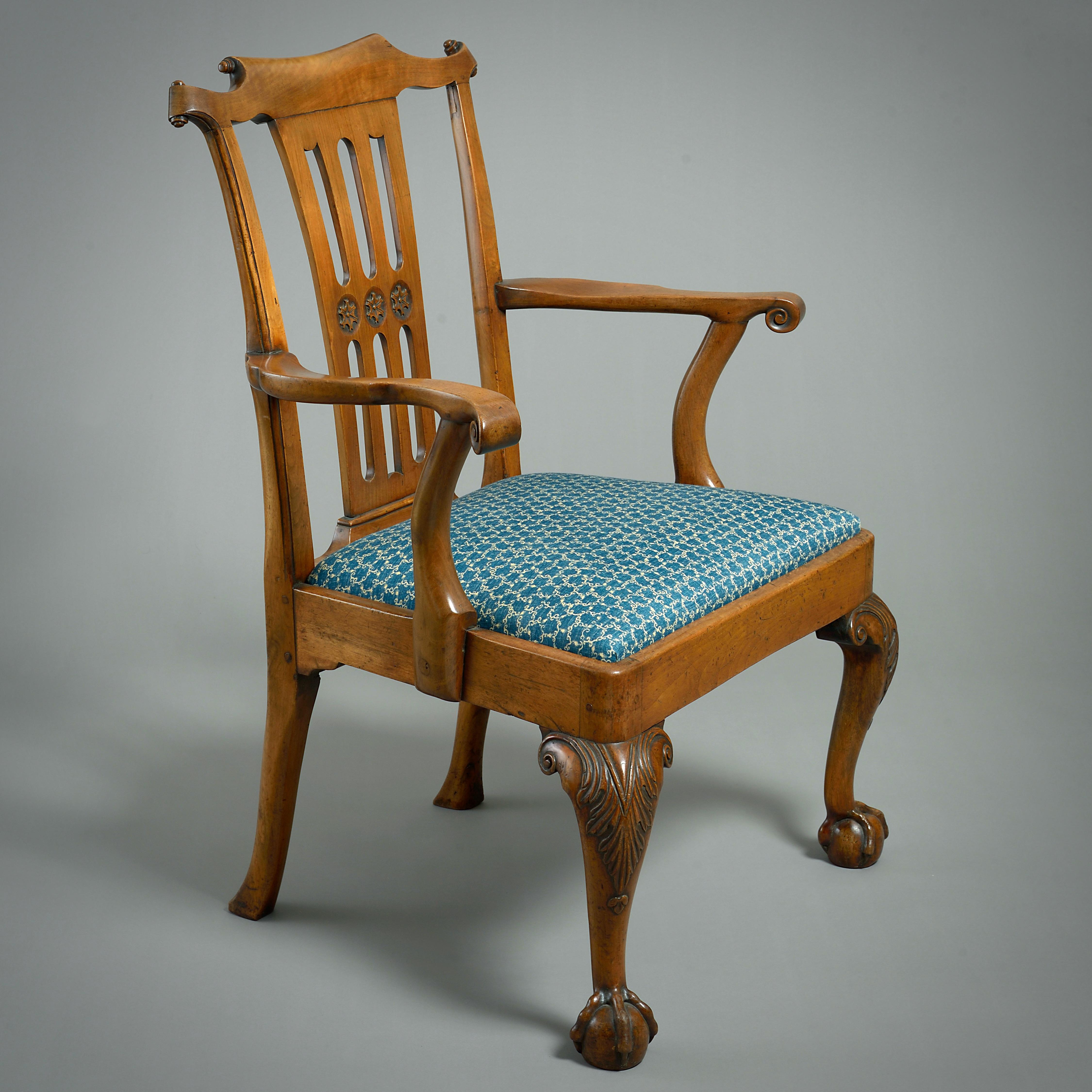 A GEORGE II FRUITWOOD OPEN ARMCHAIR, CIRCA 1750.

With pierced splat, scrolled arms and acanthus-carved cabriole legs.