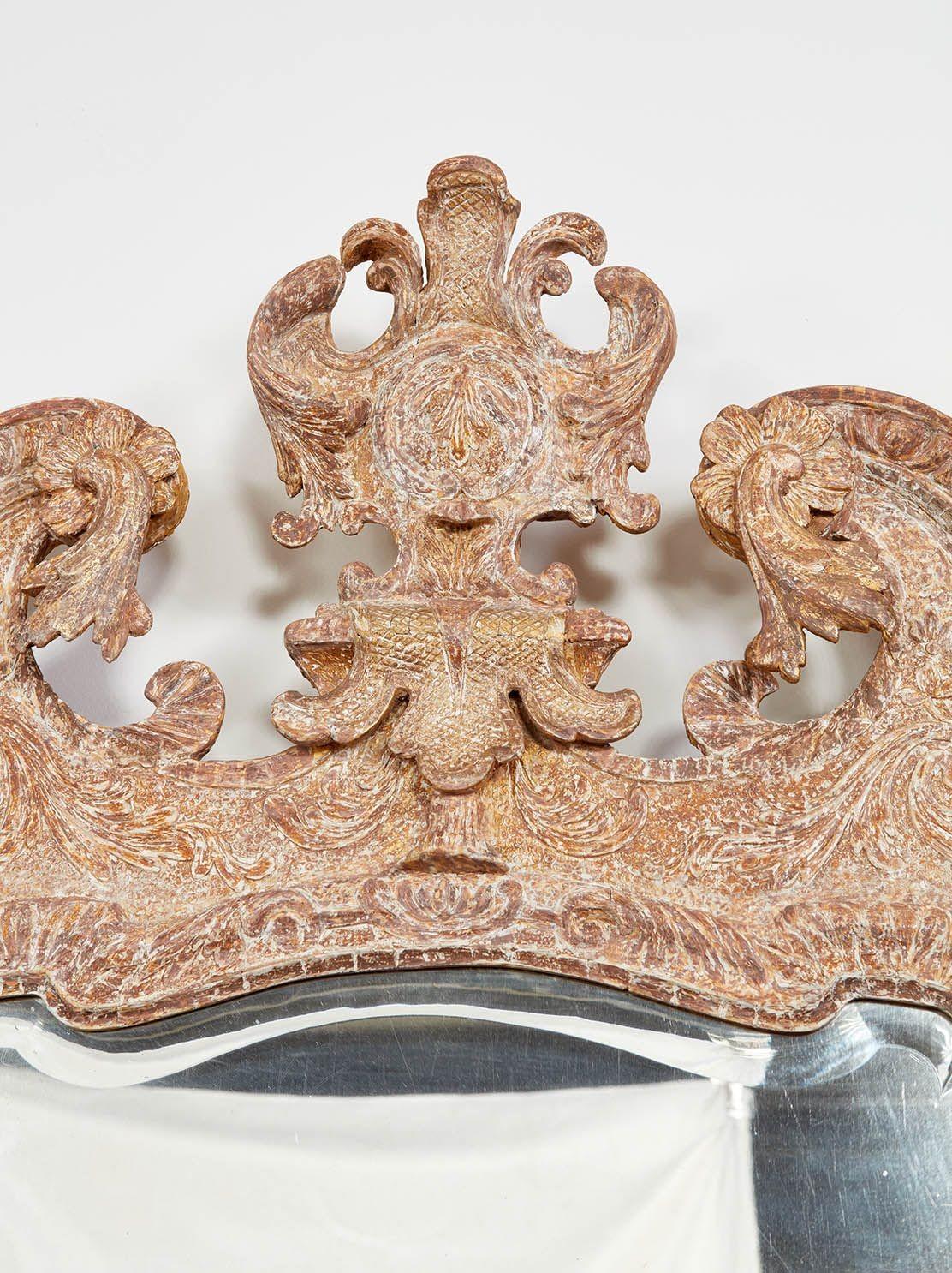 Fine George II gesso carved gilt mirror, the foliate carved cartouche with checkered ground surmounted by swan neck pediment over original shaped and beveled mercury glass plate with leaf carved surround, the lower section with scallop shell