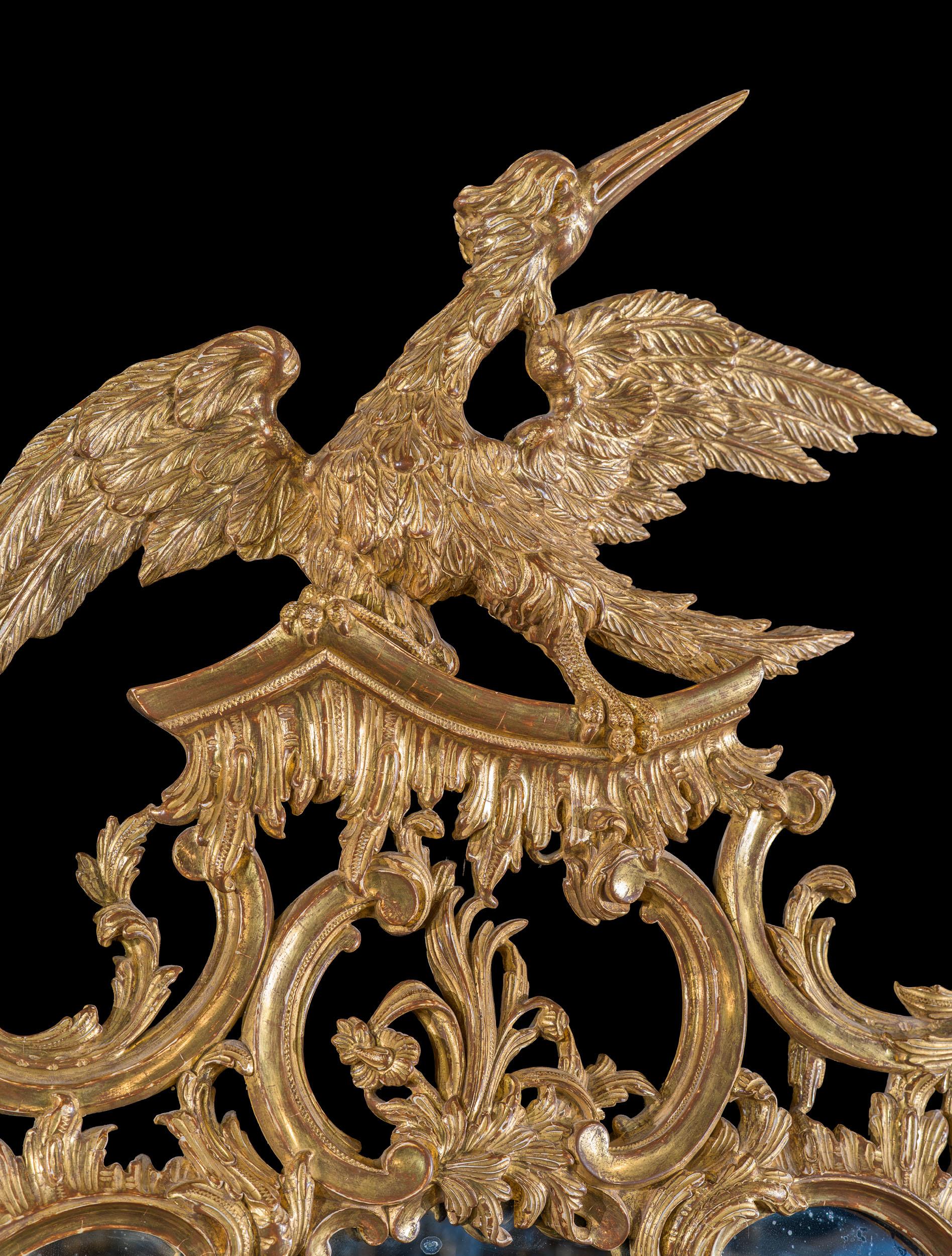 Un miroir de grande taille et d'une extraordinaire finesse, de style George II, à la manière de Thomas Johnson (1723-1778). Le cadre en bois doré est finement sculpté, reprenant l'asymétrie du style rococo, avec des volutes, des rocailles, des