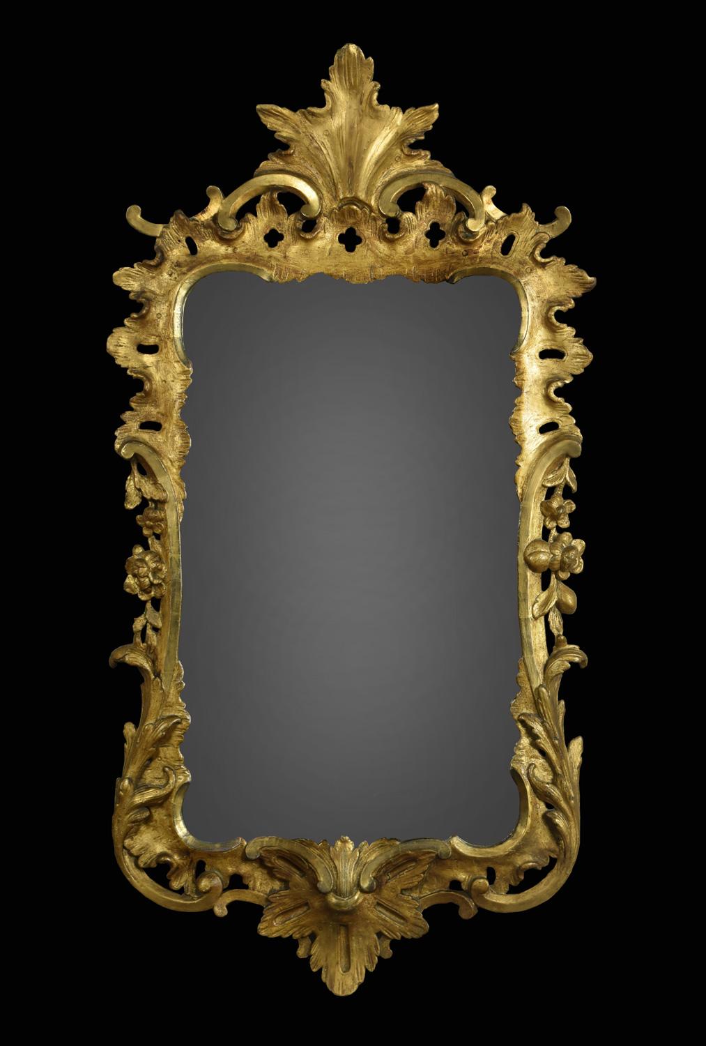 George II style giltwood wall mirror with carved foliated pierced frame surrounding the original mirror plate.

Dimensions:
Height 49 inches,
width 26 inches,
depth 3 inches.