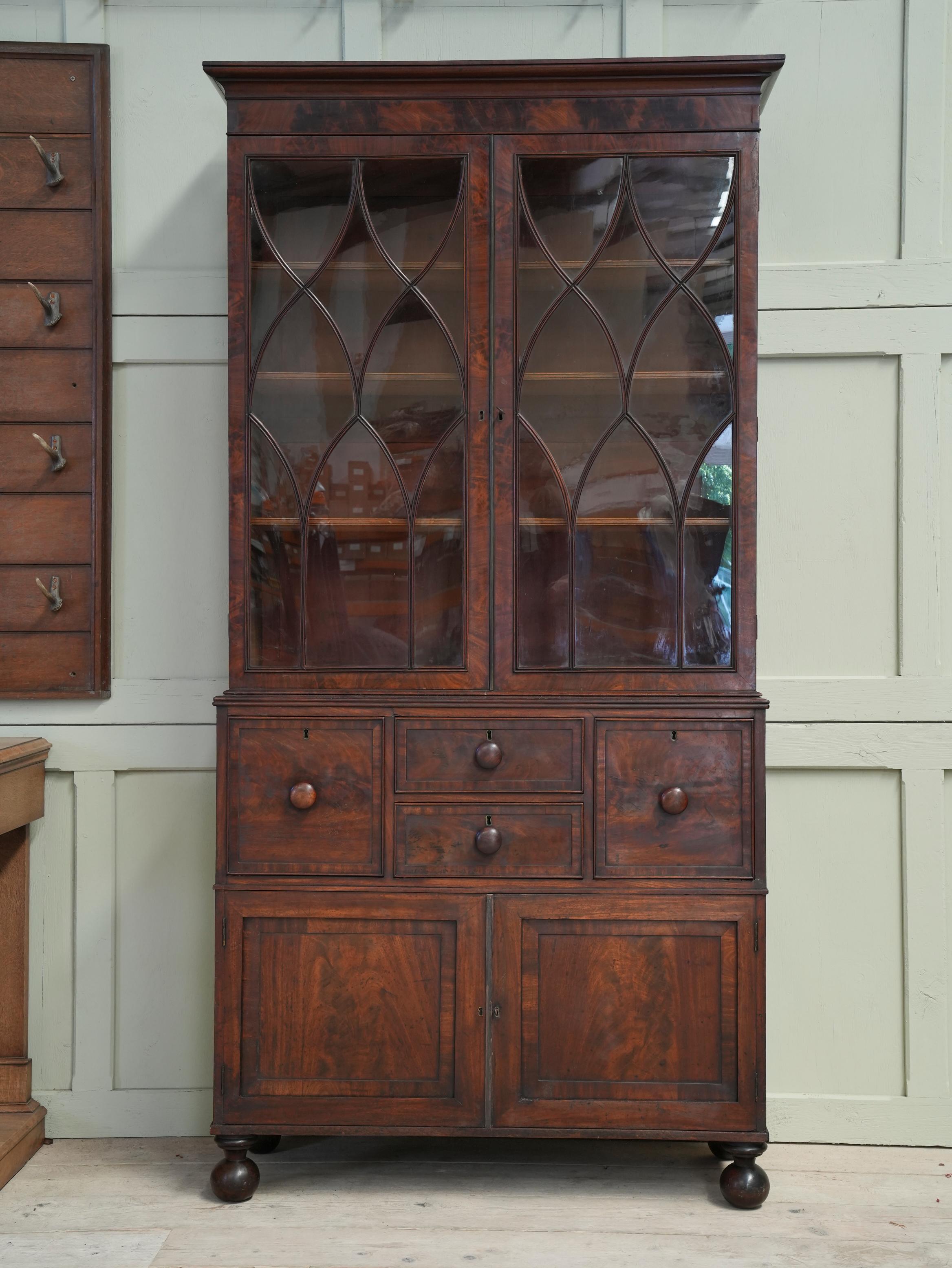 The astralgal glazed doors above four drawers, one being a lead lined cellarette, solid fielded panel doors below.

Elegant and a good narrow size with well chosen mahogany throughout.