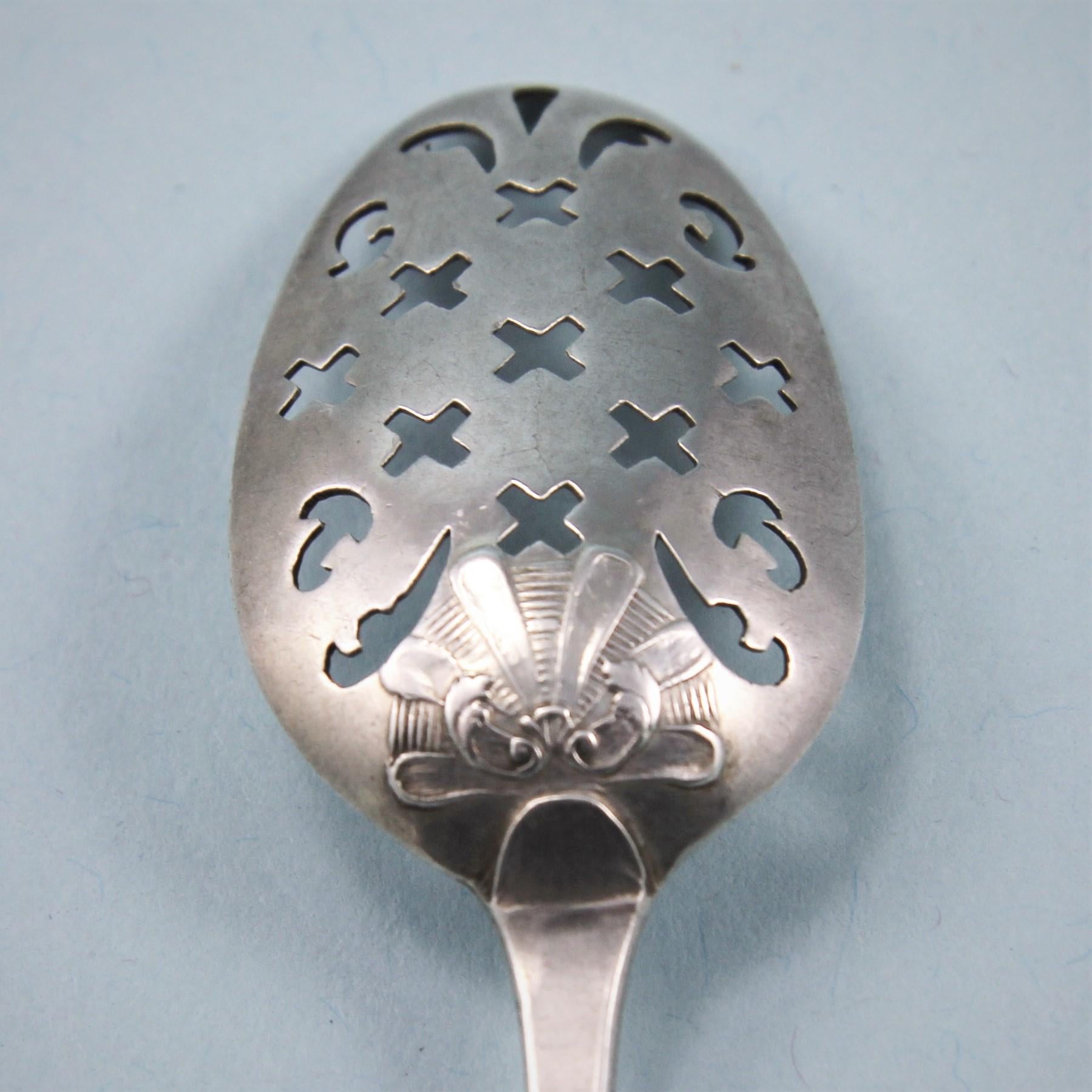 Very fine George II/III sterling silver shellback mote spoon with a well defined barb at the end of the stem.
London, circa 1760. 

The maker's mark H.B. is stamped on the back of the stem and the very attractive shell on the reverse of the bowl