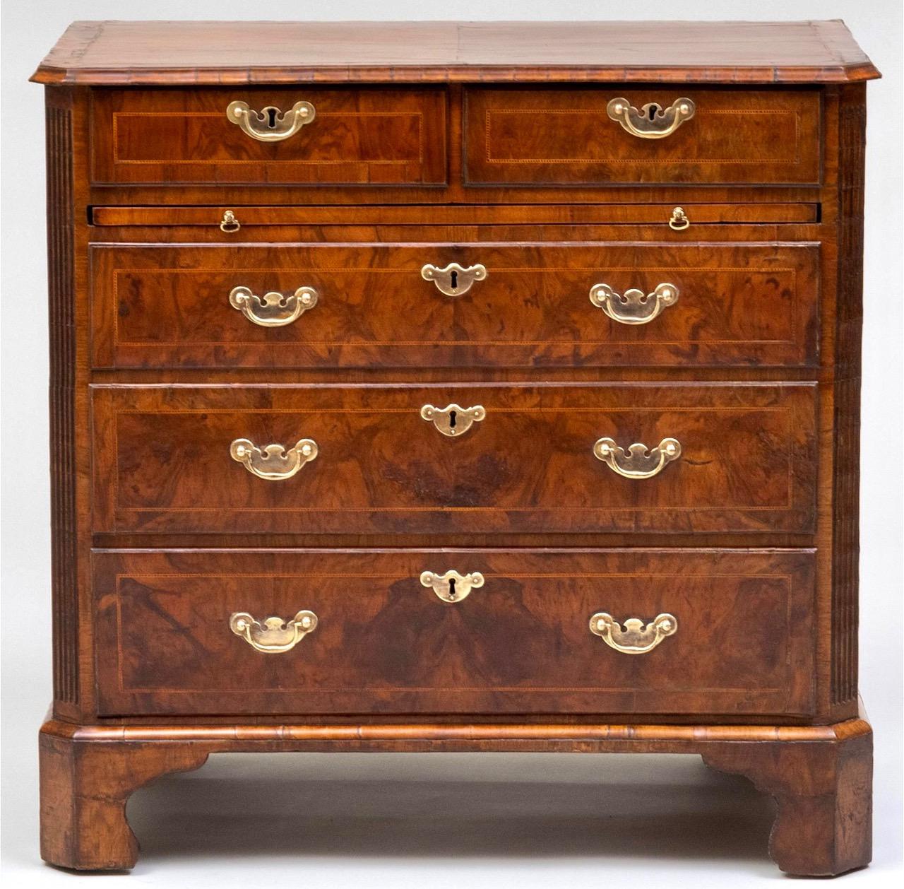 A very fine circa 1730 English late George I, early George II period beautifully age patinated bookmatched walnut and 'micro-dentil' boxwood inlaid chest of atypical drawer configuration, the molded-edge top on front canted and fluted corner case,