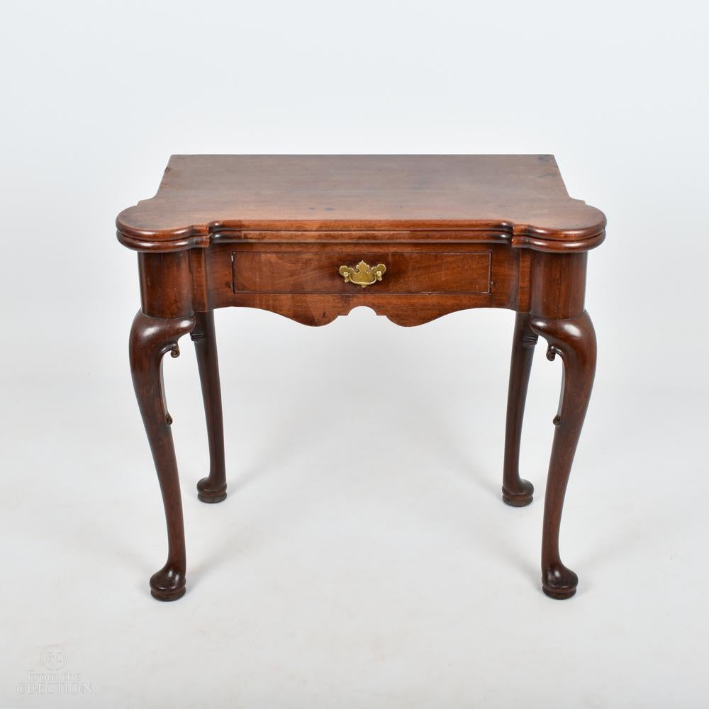 George II Irish Mahogany fold out games table on four pad feet with a single drawer to the front.